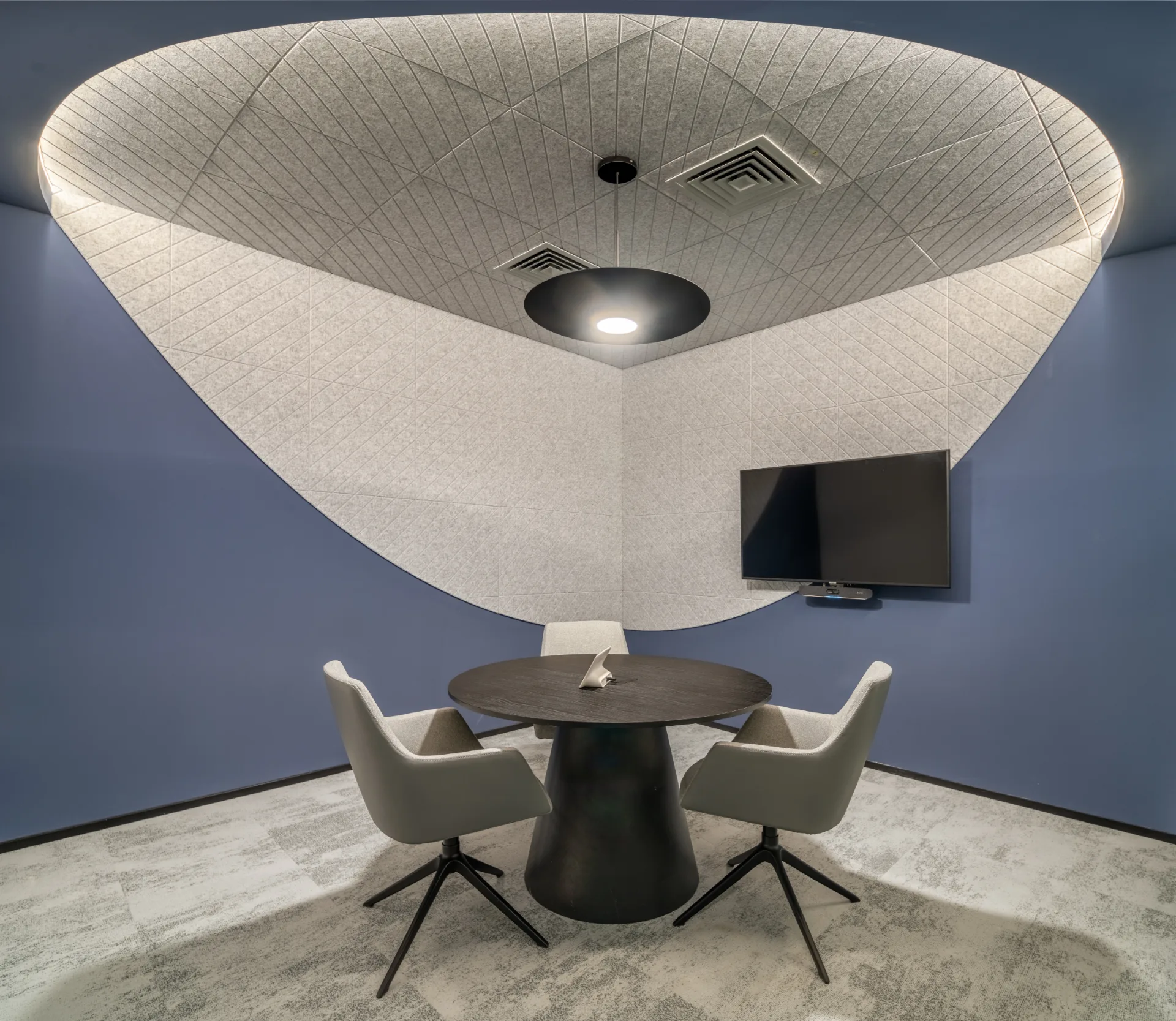 Meeting nook beneath an illuminated acoustic canopy