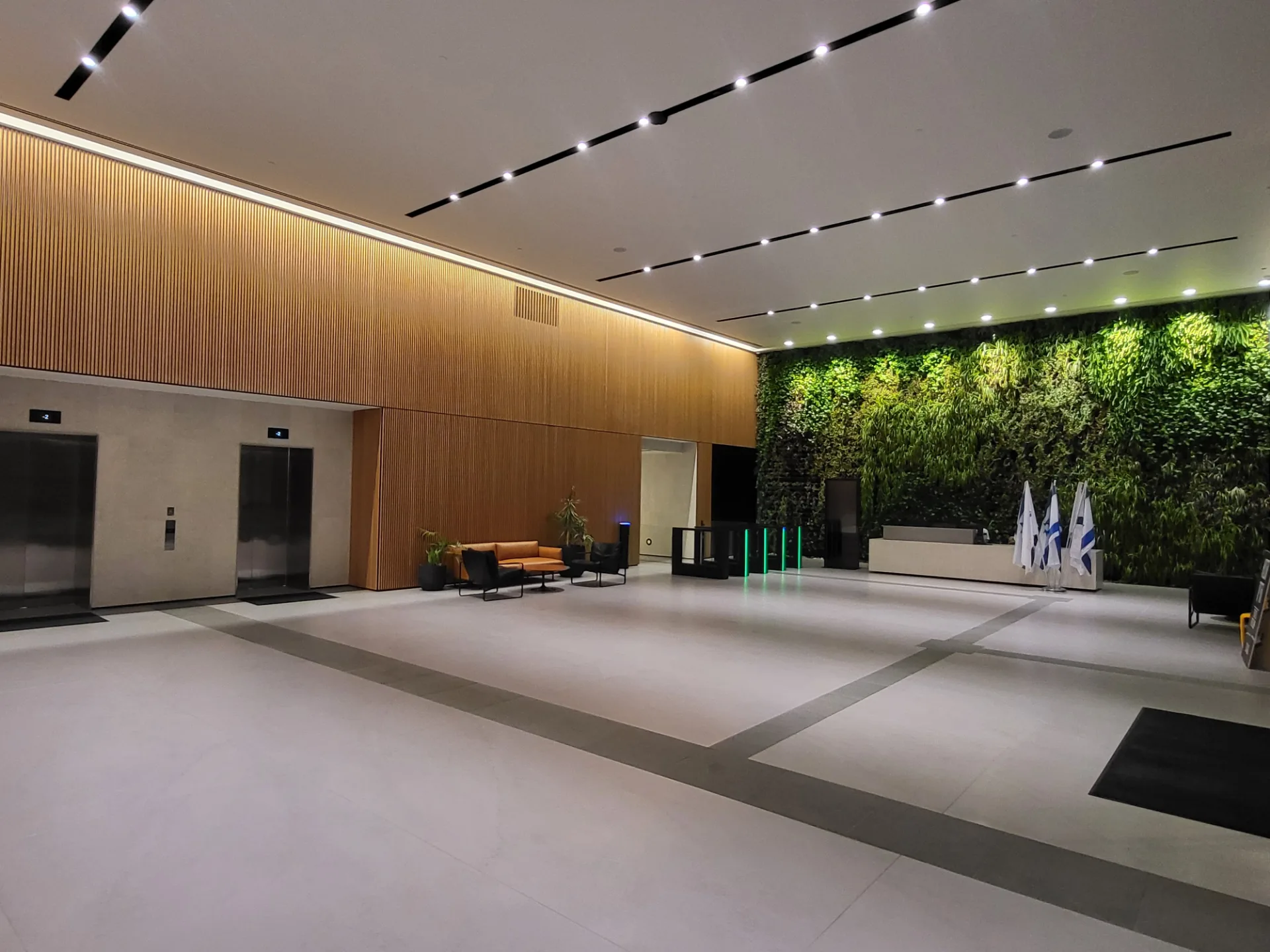 Main lobby with a timber wall and a green living wall