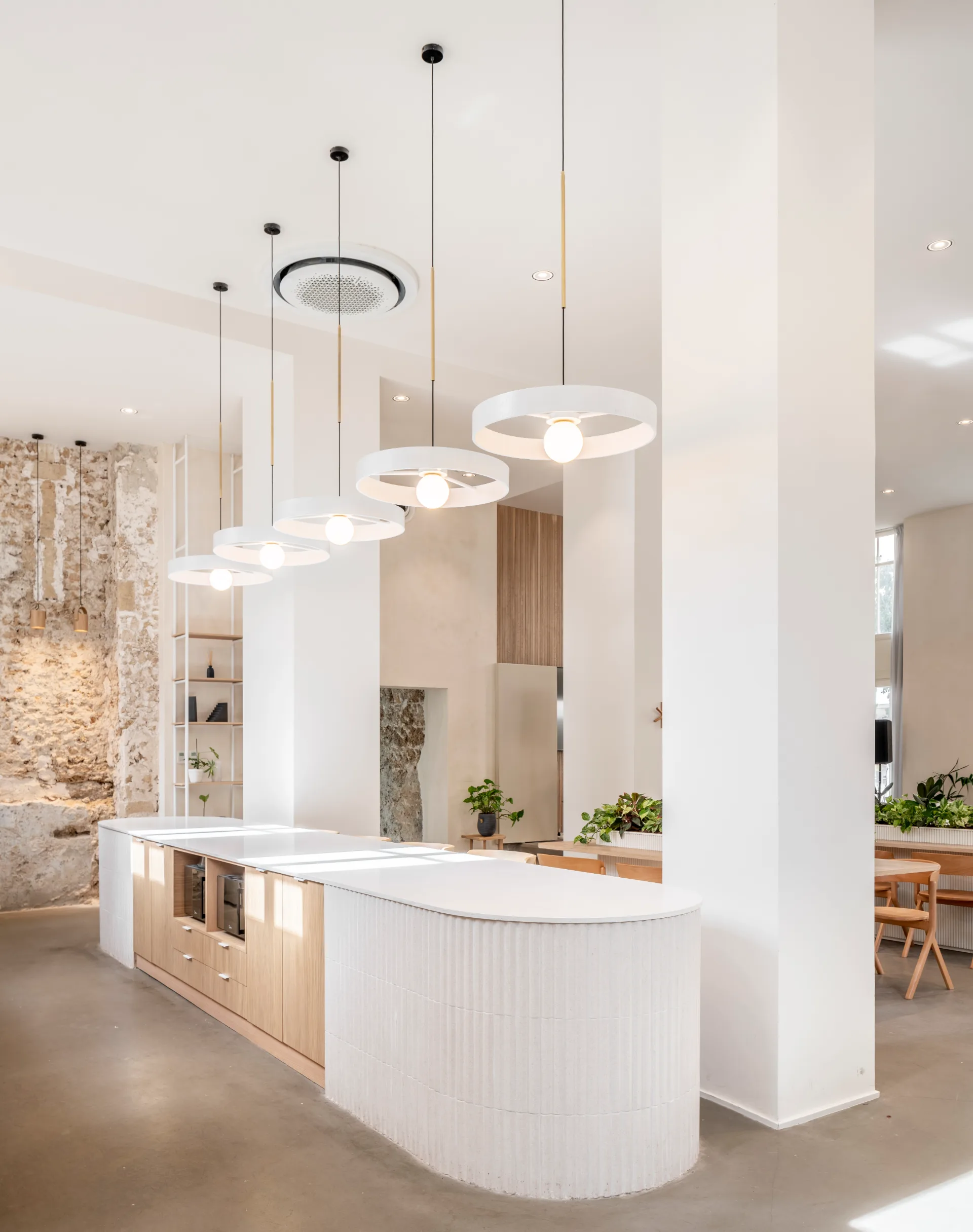 Pendant lights above the kitchen bar and brick wall