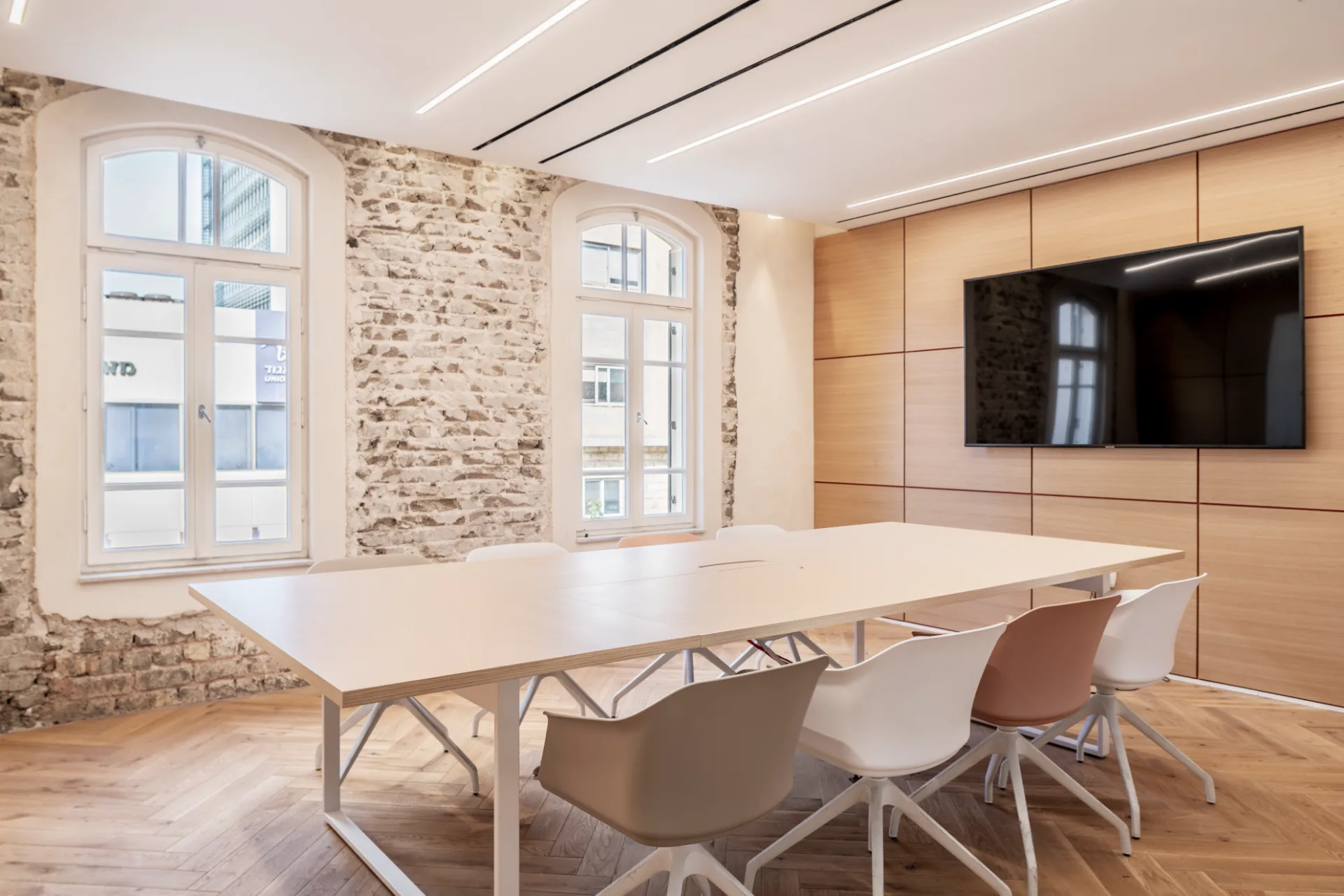 Meeting room with a brick wall and timber panelling