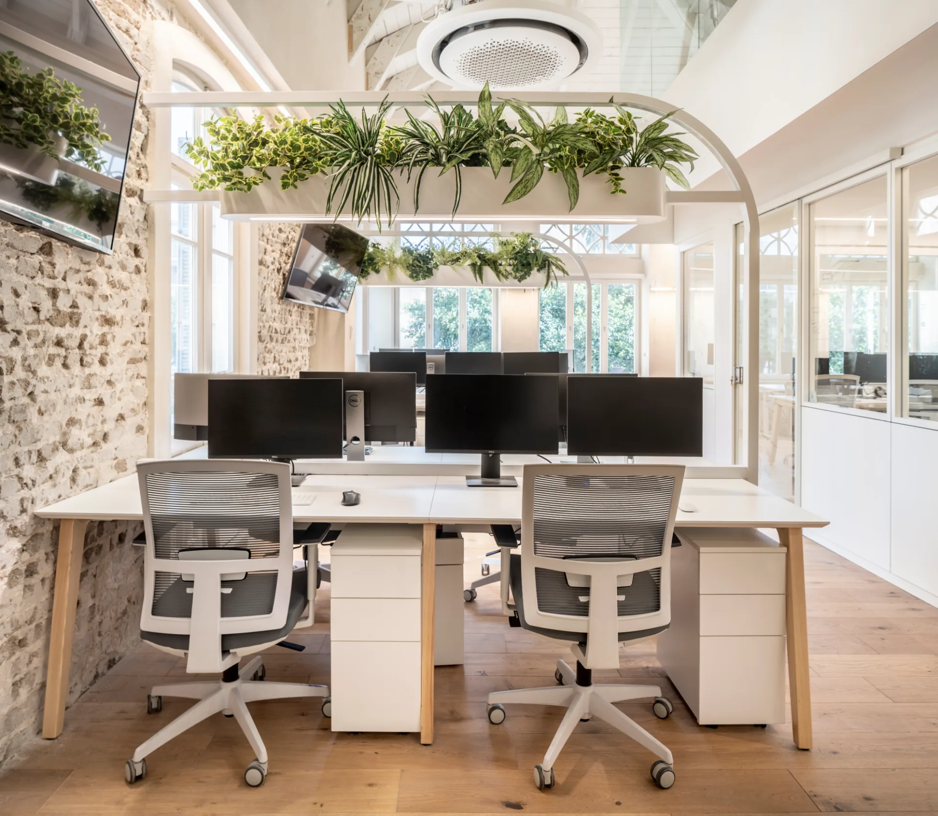 Workstations beside an exposed brick wall