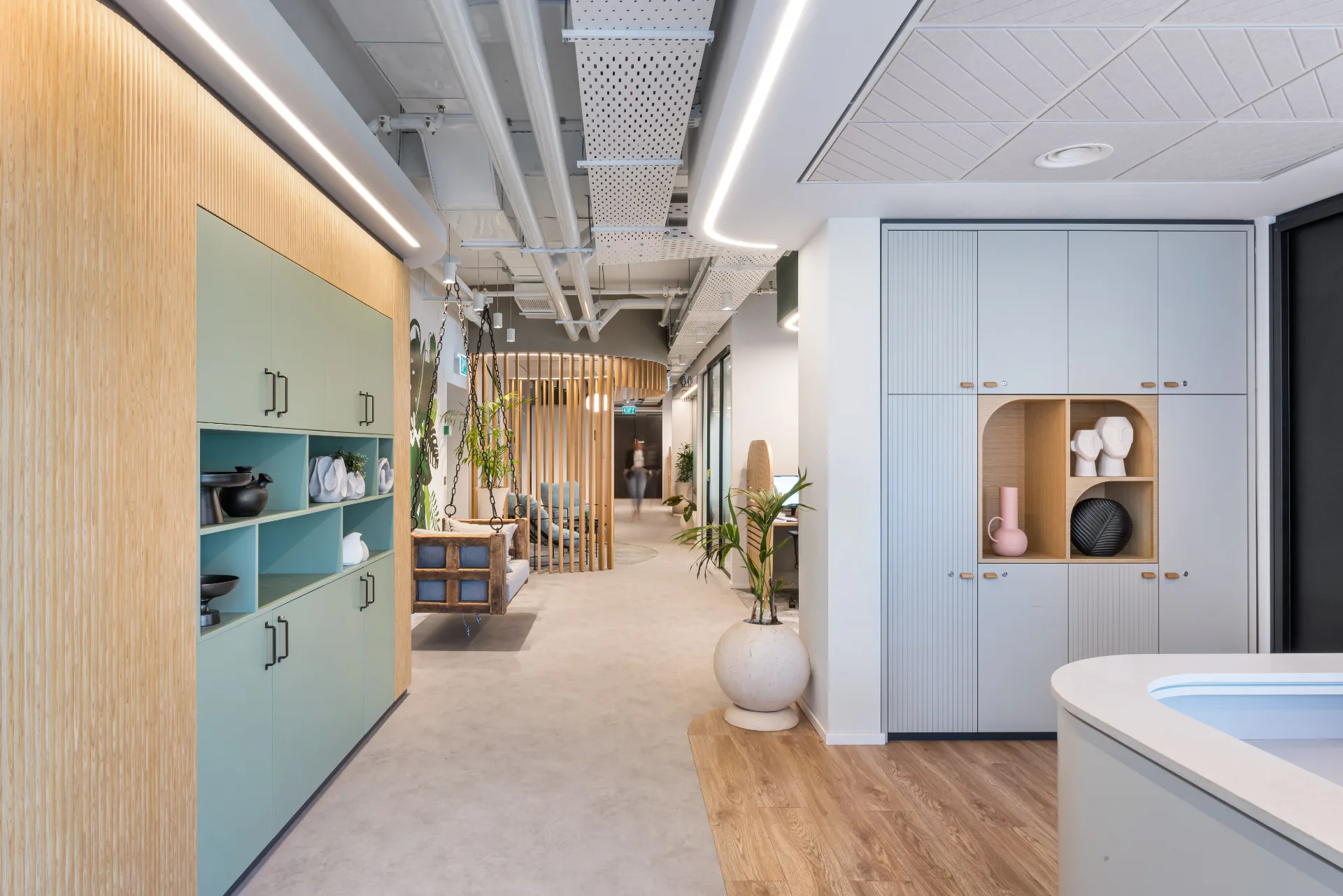 Corridor with green joinery and a hanging bench