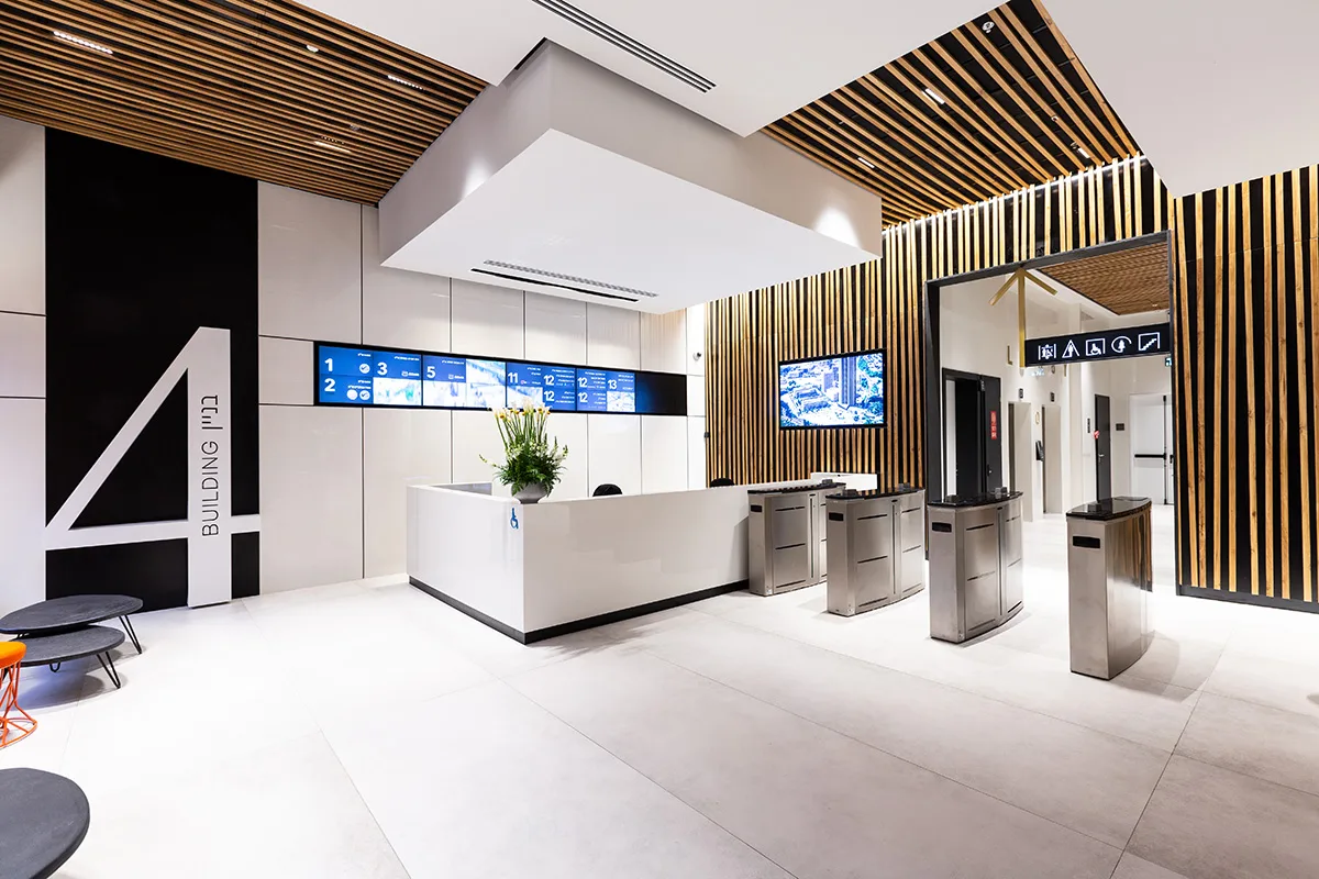 Reception desk with directory screens and turnstiles
