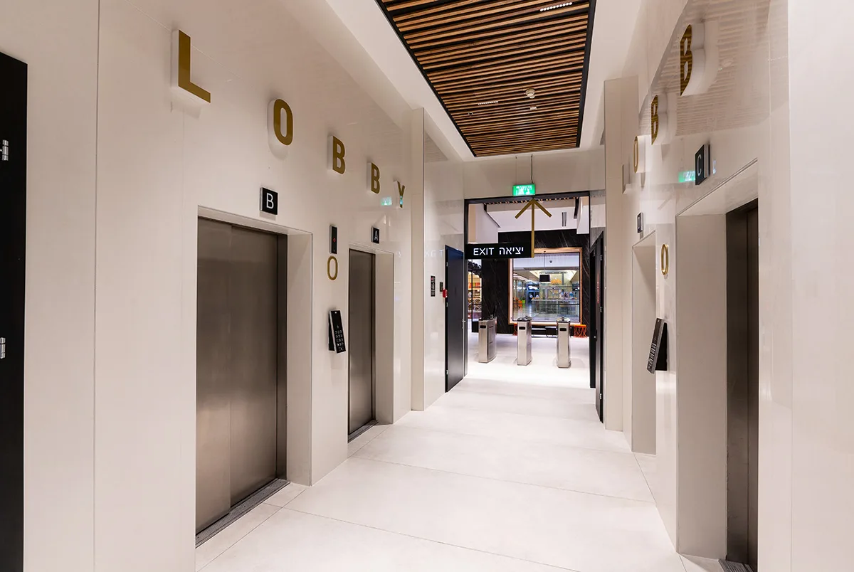 Elevator lobby with gold lettering on the wall