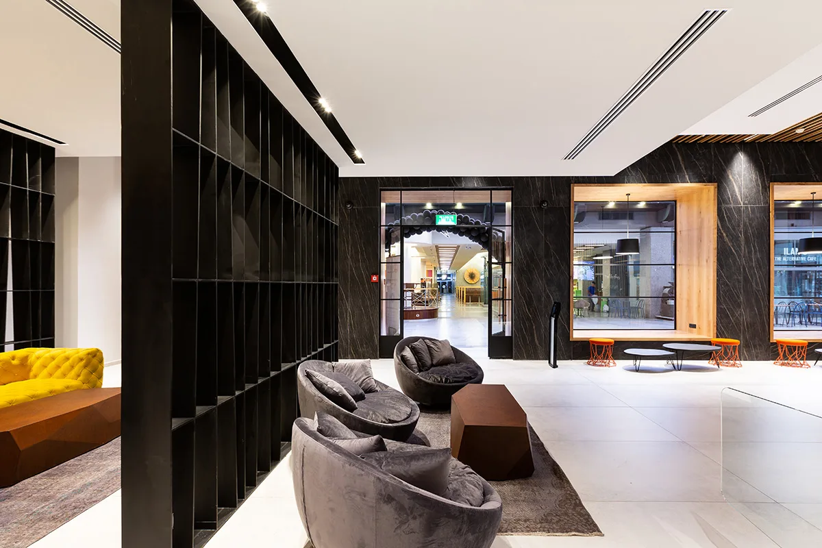 Black stone wall with timber-framed café windows