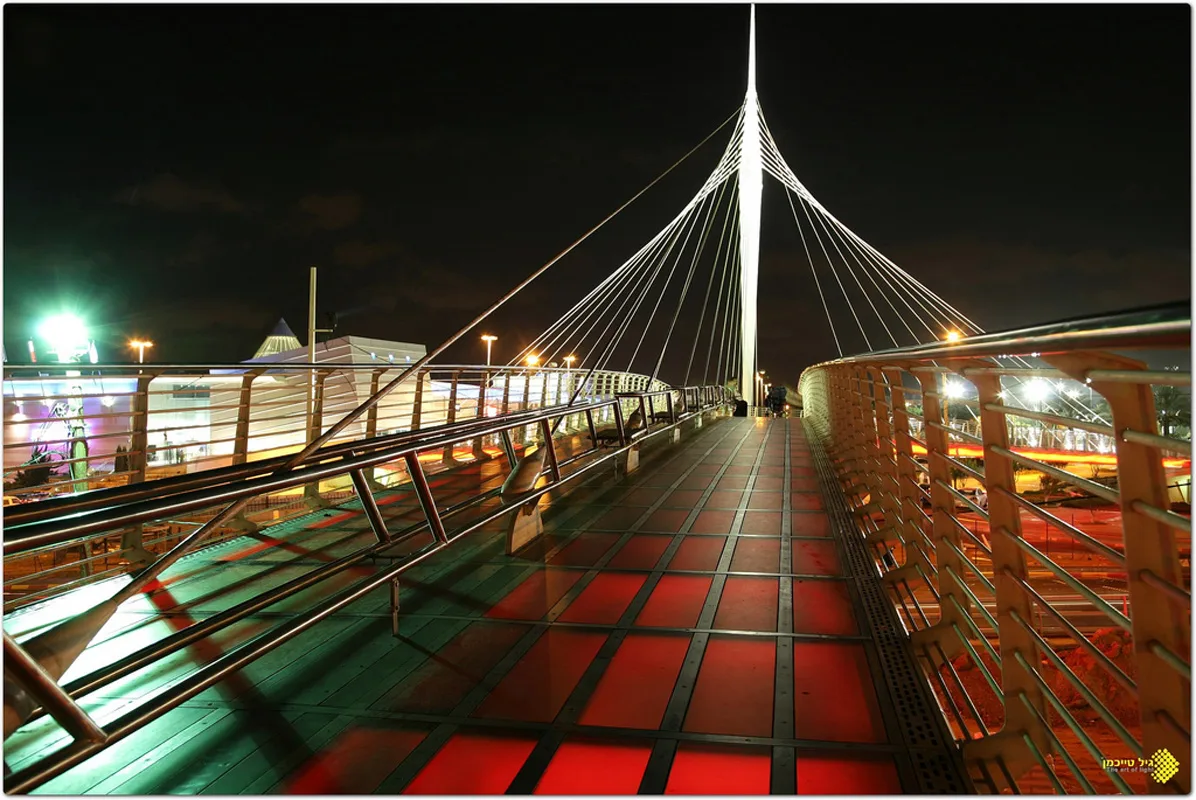 The bridge deck and lit mast with red glowing pavers