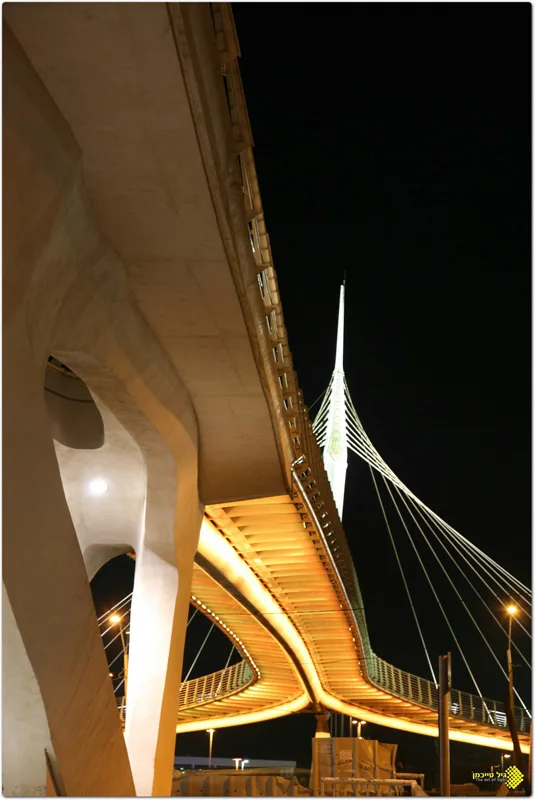 The amber-lit soffit and white mast seen from below