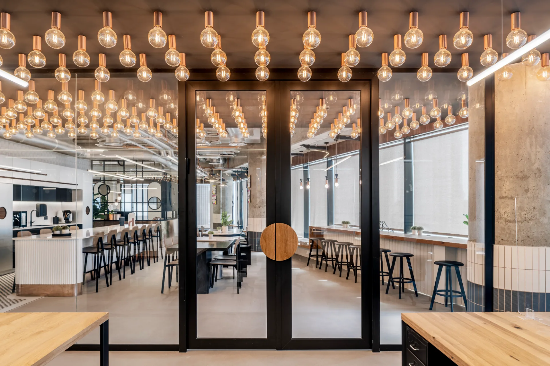 Canopy of warm Edison bulbs above the cafe area