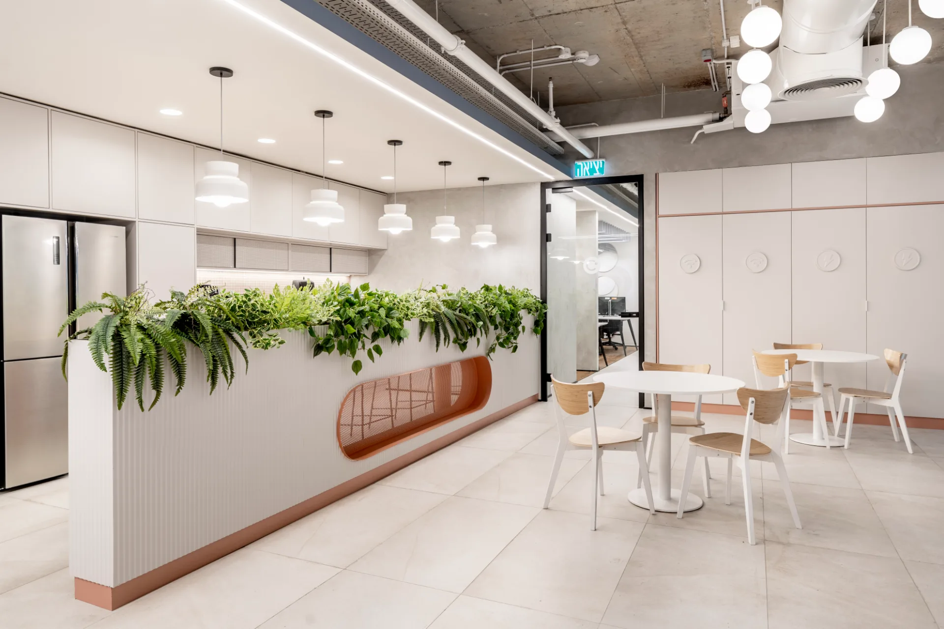 Kitchenette with a planter and arched mirrors