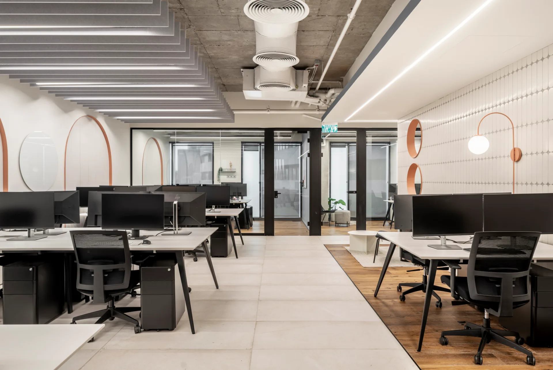 Work area with arched partitions and wall sconces
