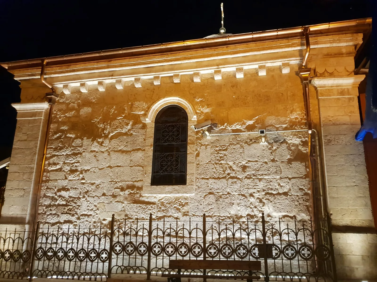 Illuminated stone facade with an arched window
