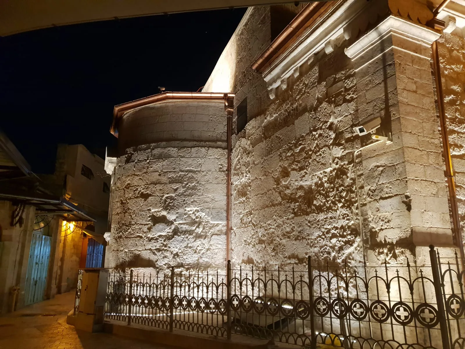 The lit church walls in a Christian Quarter alley