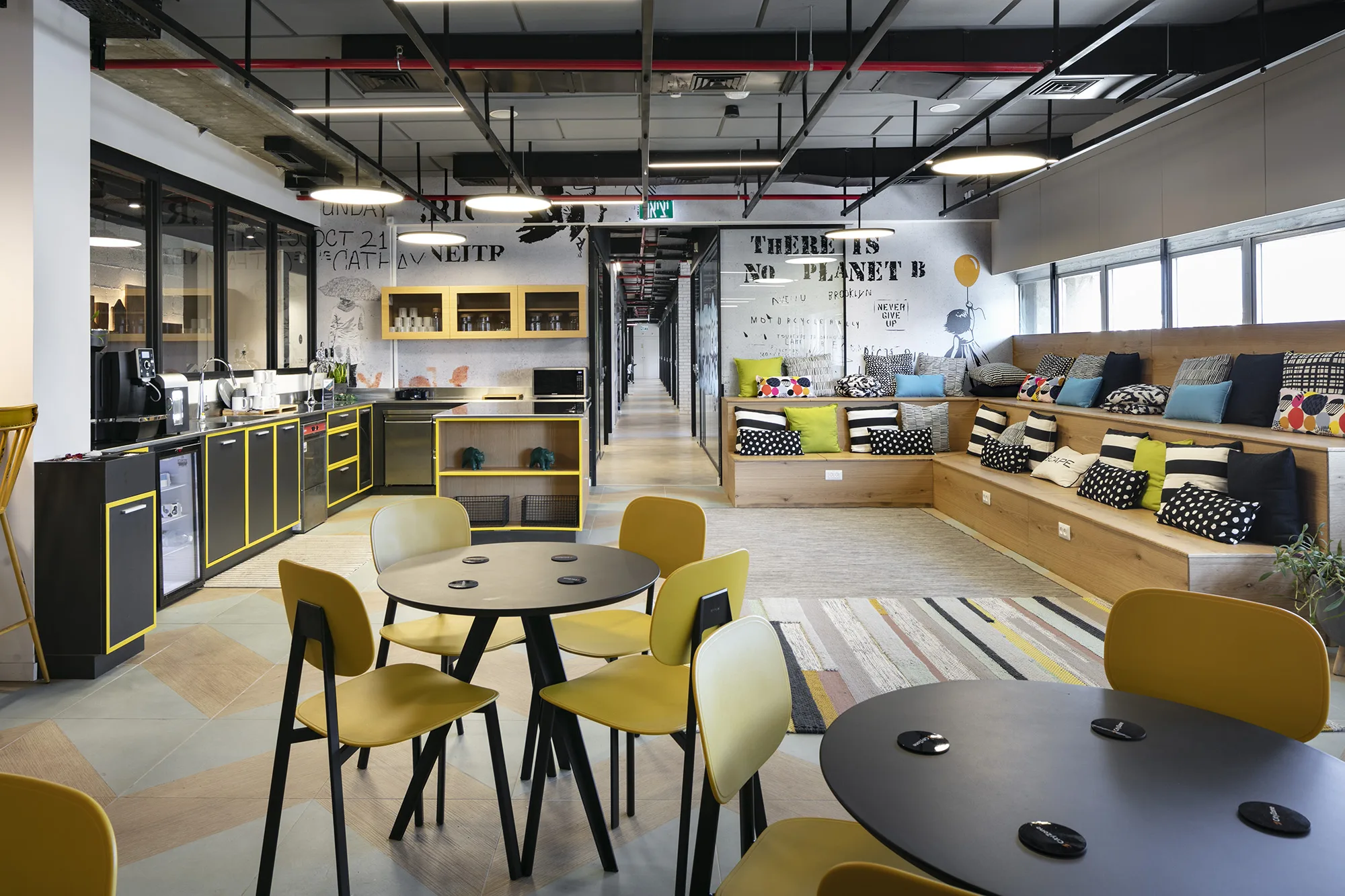 The kitchen and café with bench seating and a mural