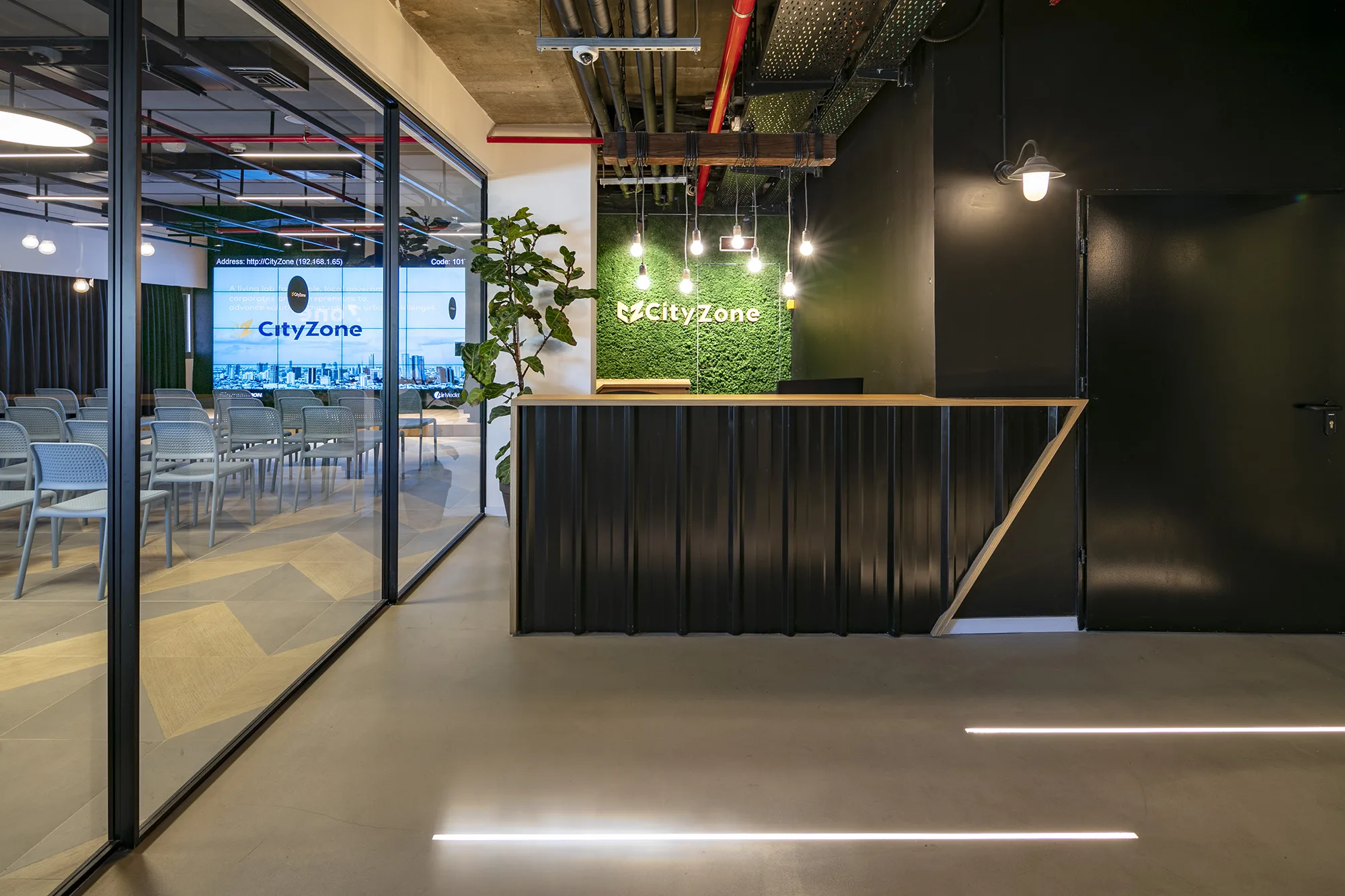 The reception desk and the green CityZone logo wall