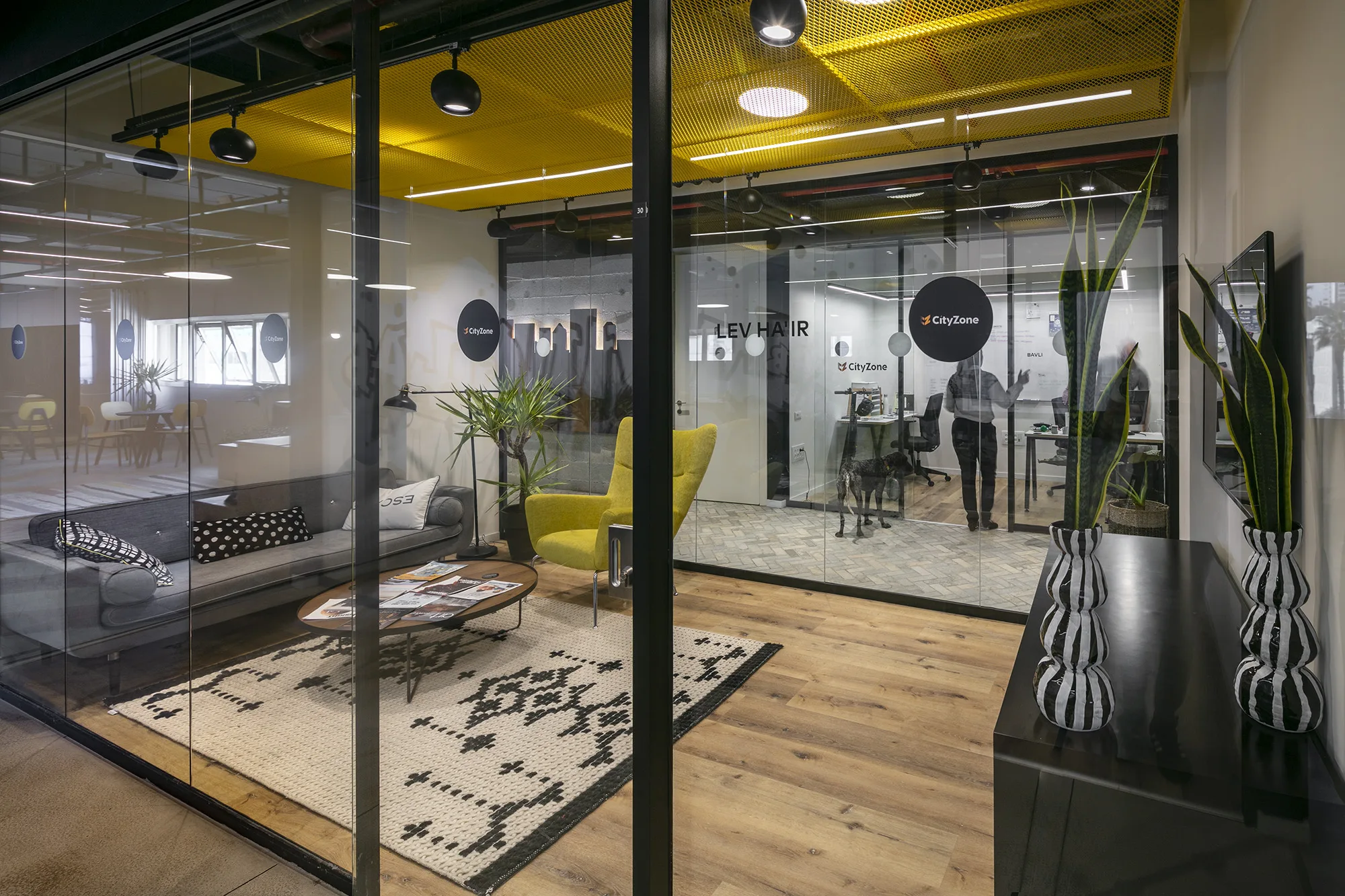 A lounge beside glass-walled tenant offices