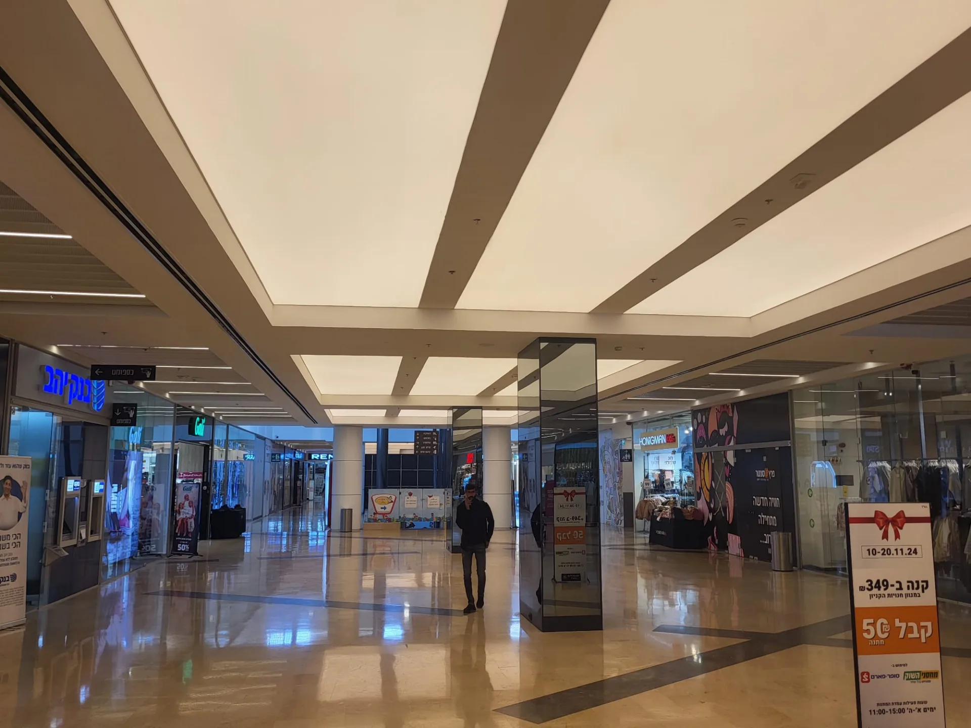 Concourse beneath backlit luminous ceiling panels