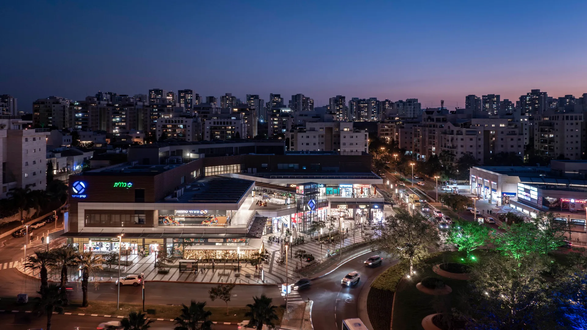 The lit mall within the Kfar Ganim neighborhood at dusk