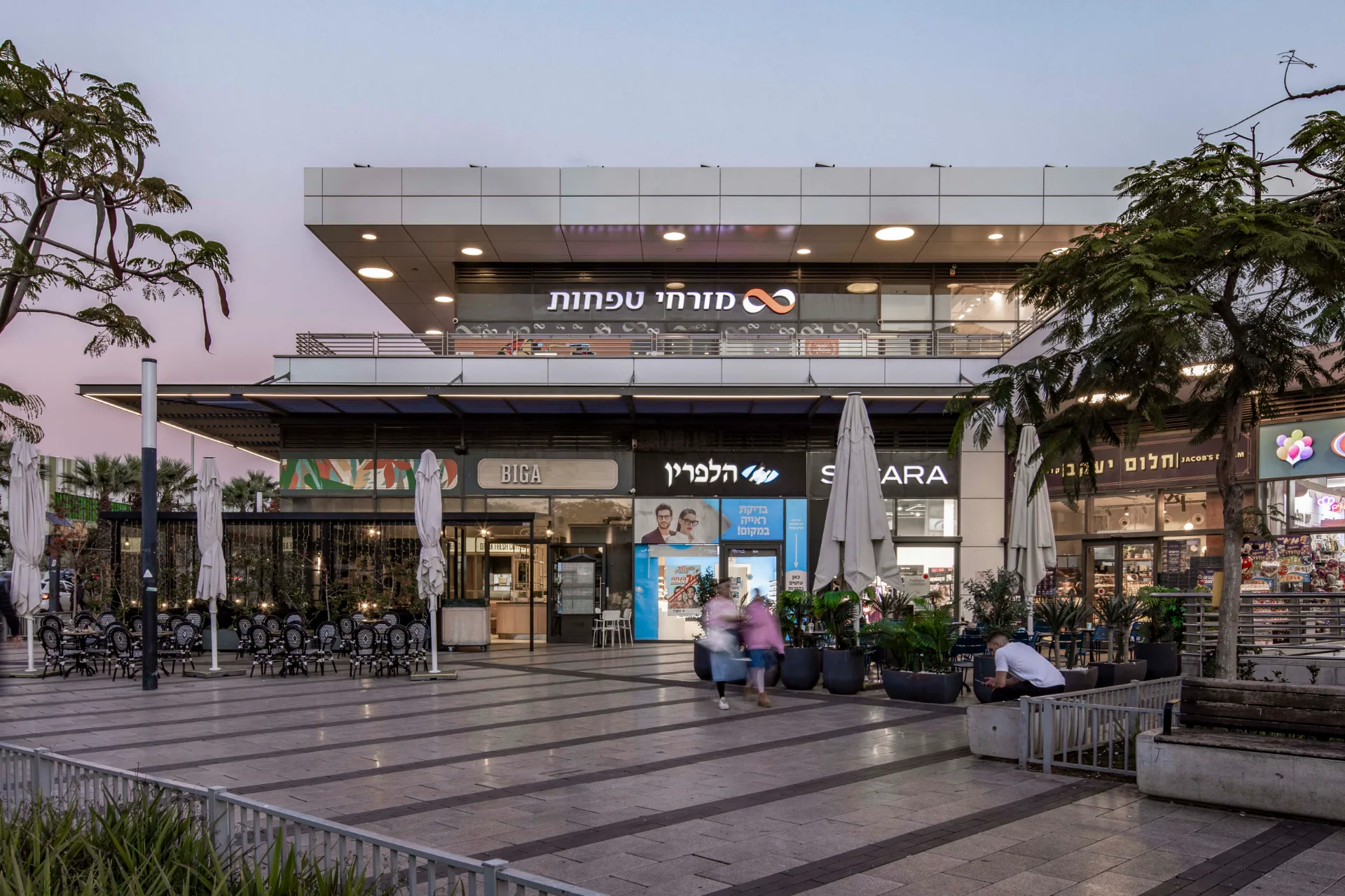 Entrance canopy and storefronts at dusk