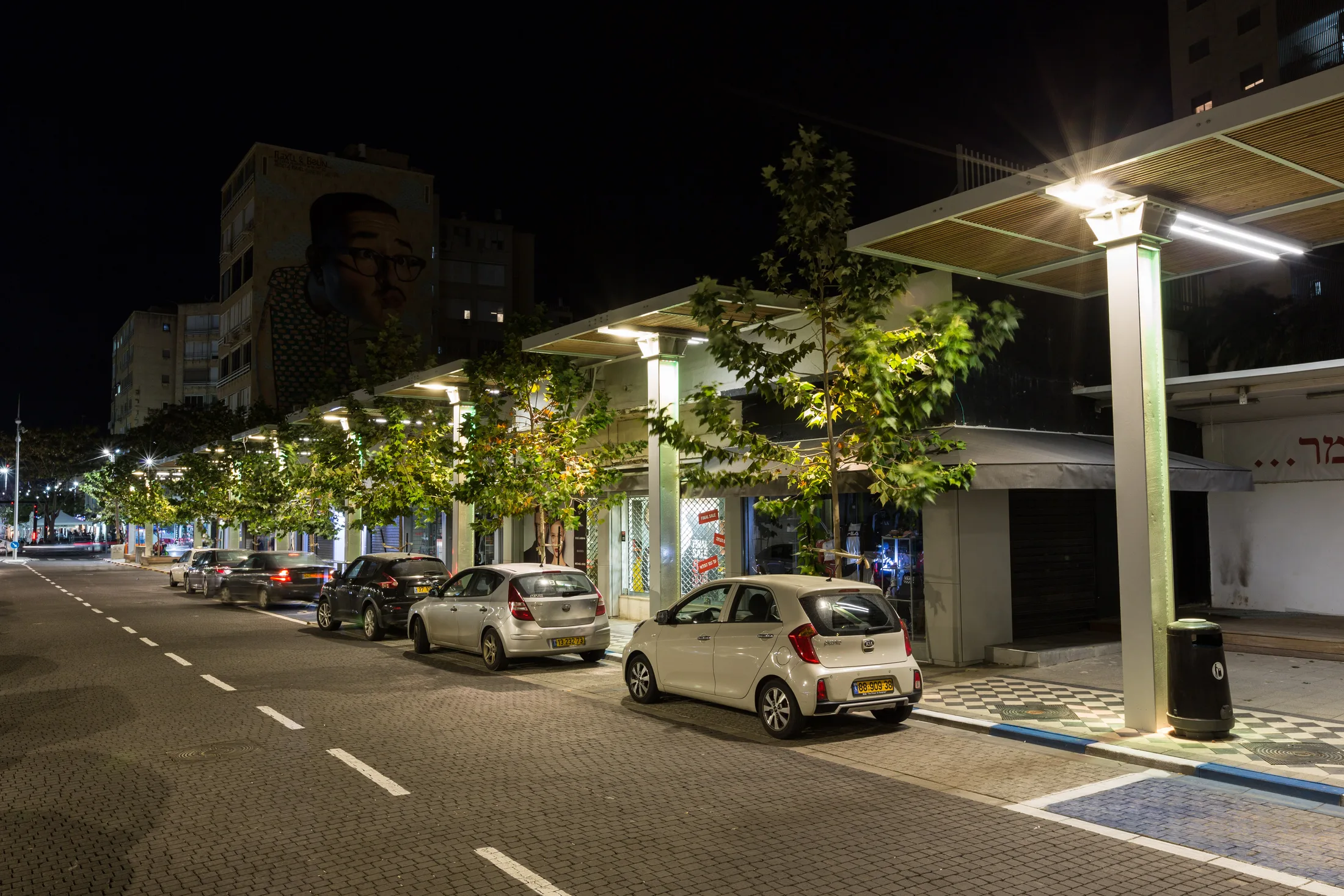 The street in the evening with modern lighting poles and traffic