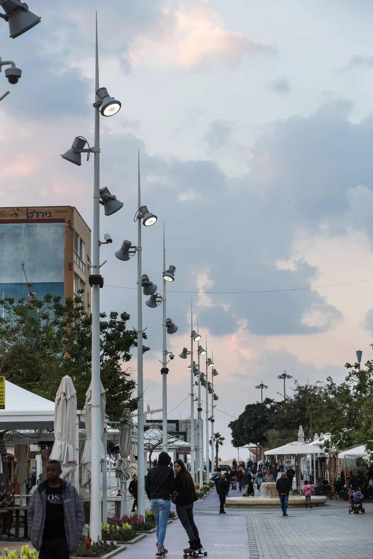 A lighting pole with luminaires and a city backdrop