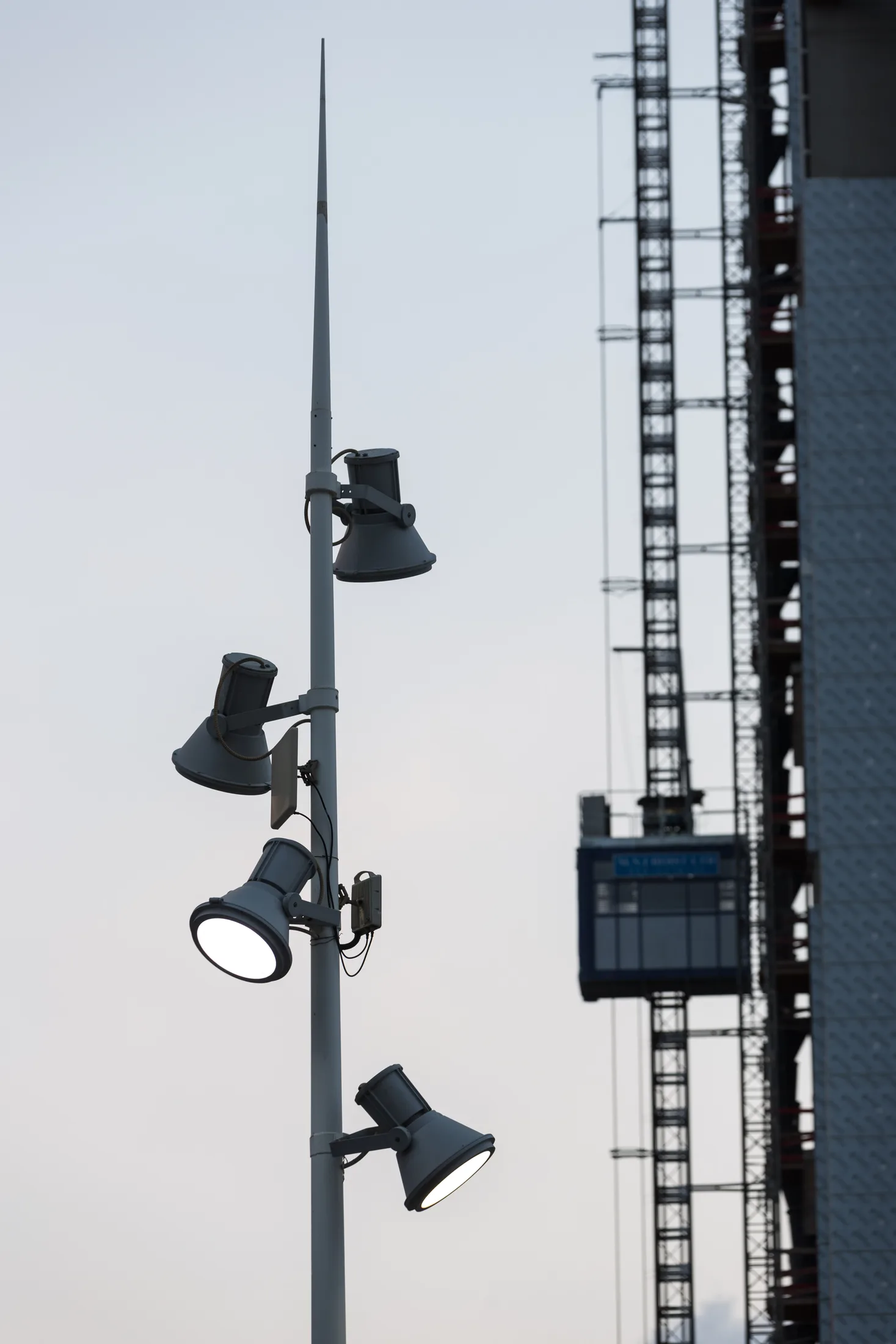 A detail of floodlight fixtures on a lighting pole