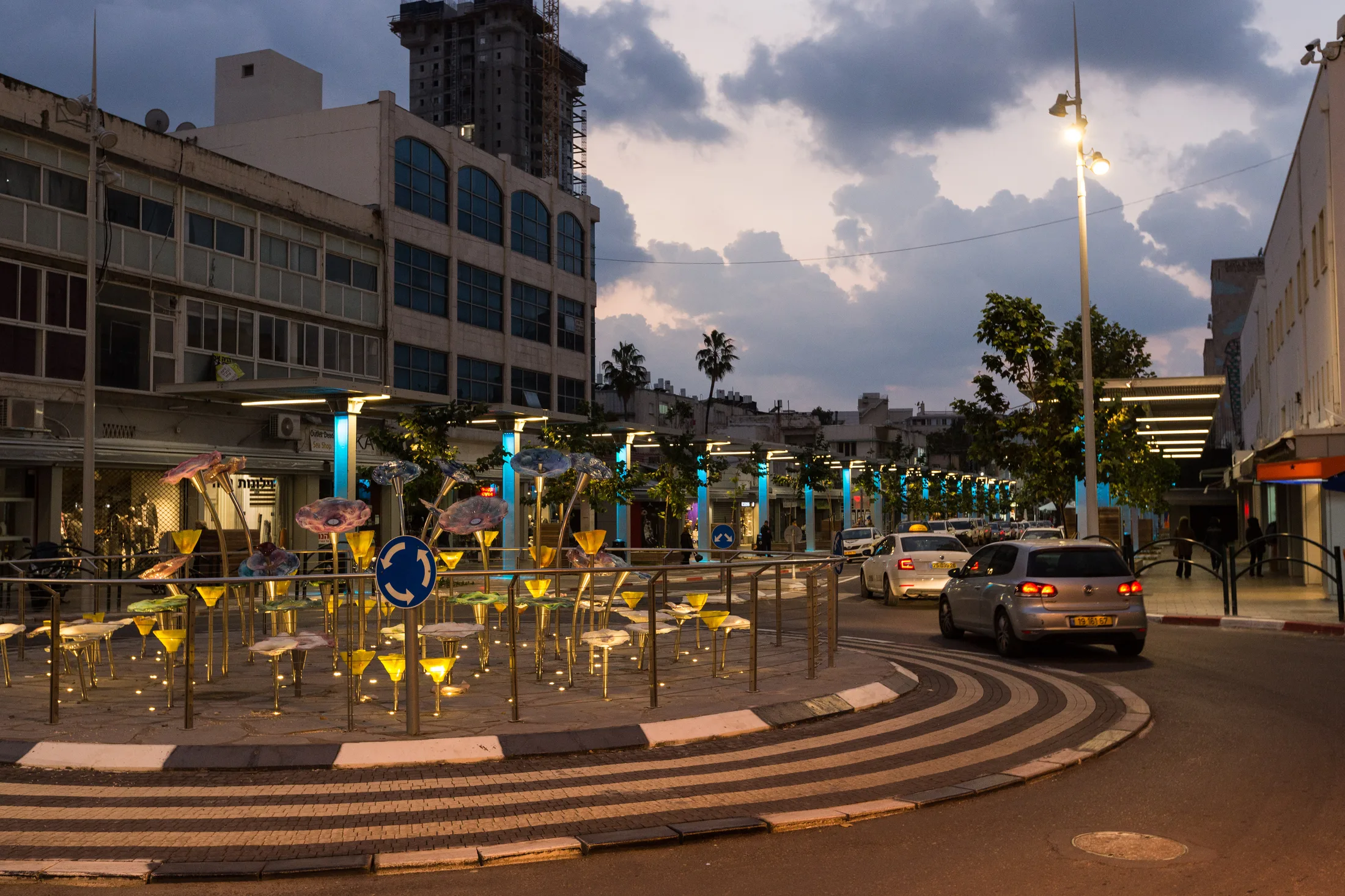 The lit flower installation at night with light trails