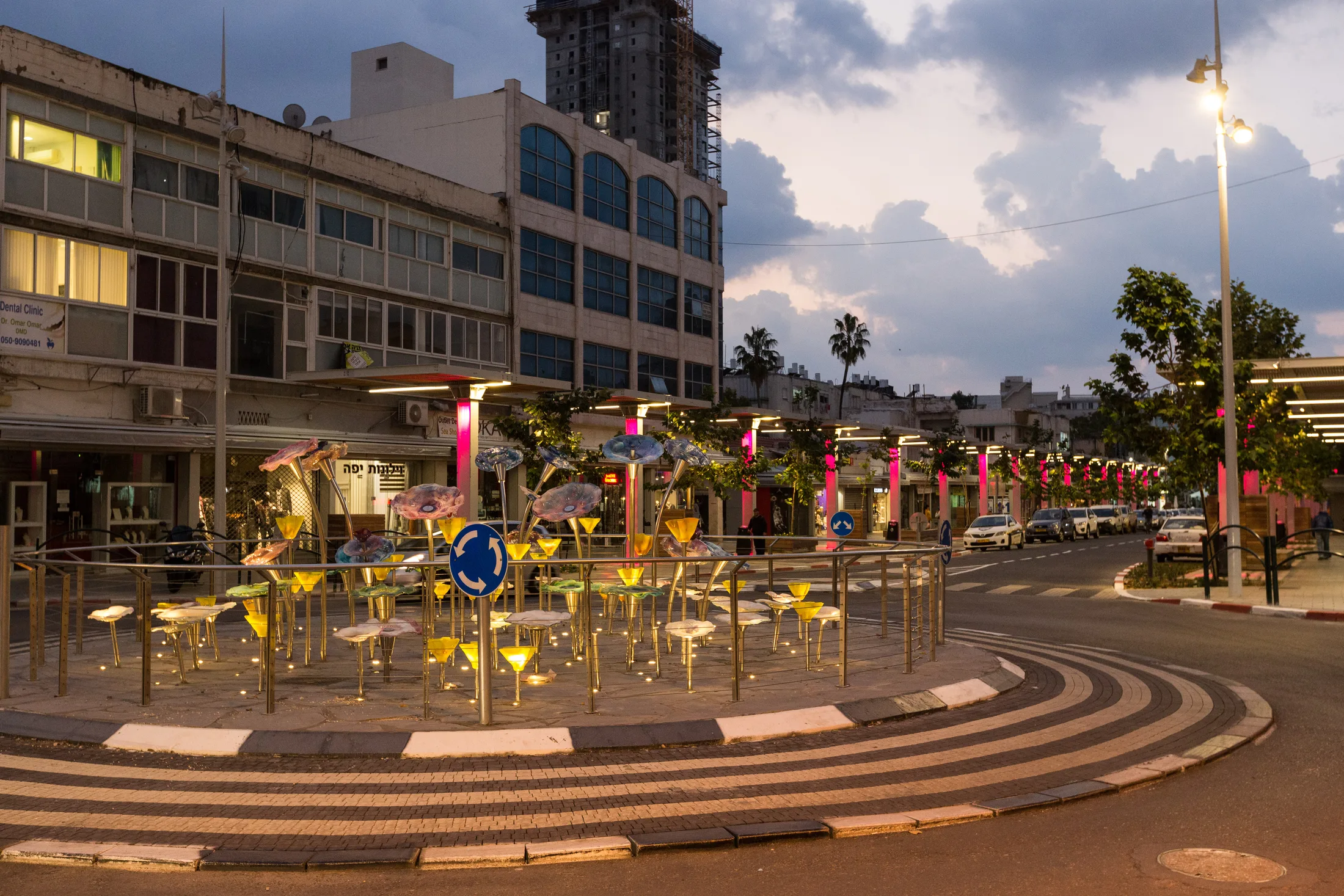 The sculptural light installation beside the street at twilight