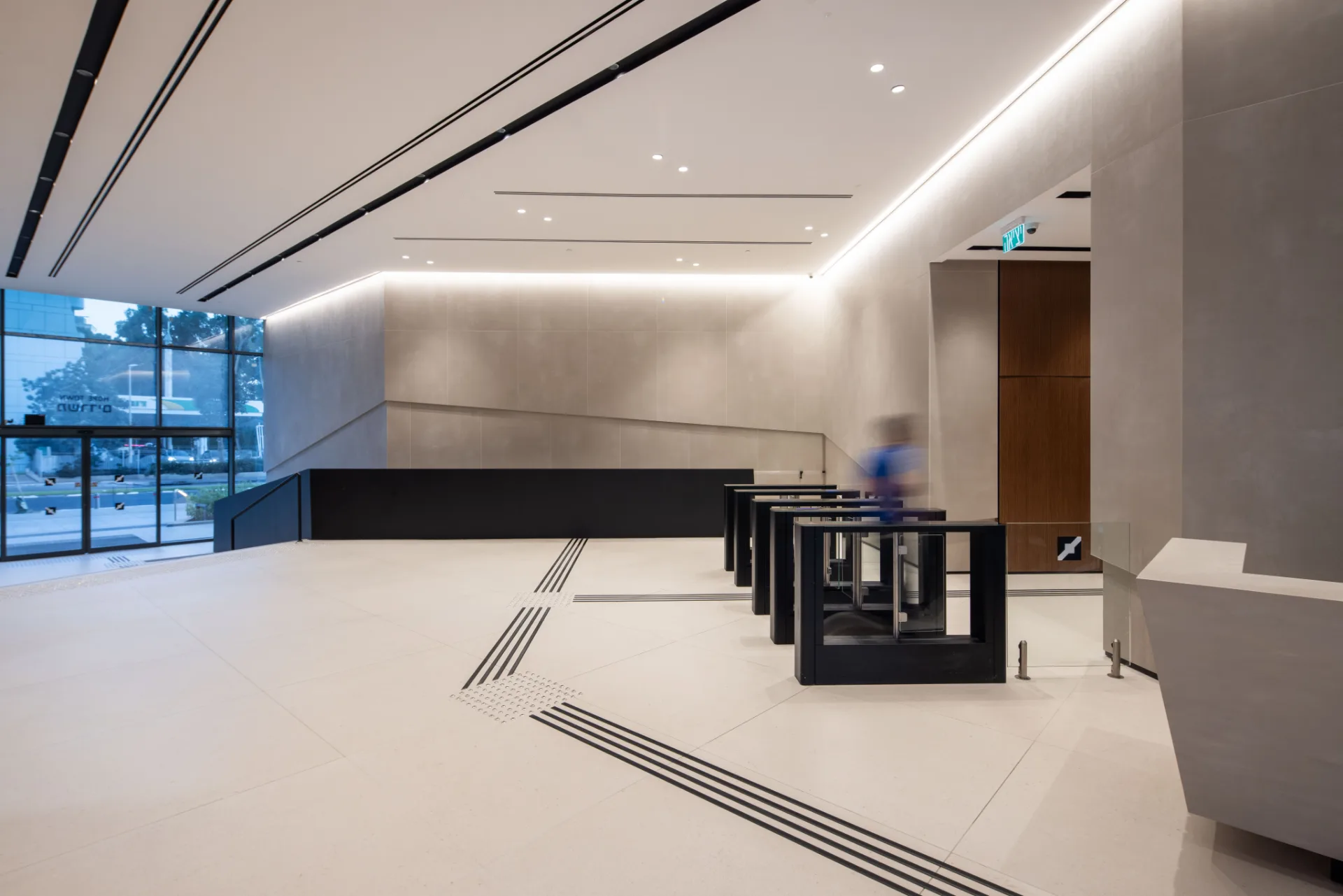 Angular lobby with a feature stair under linear lighting