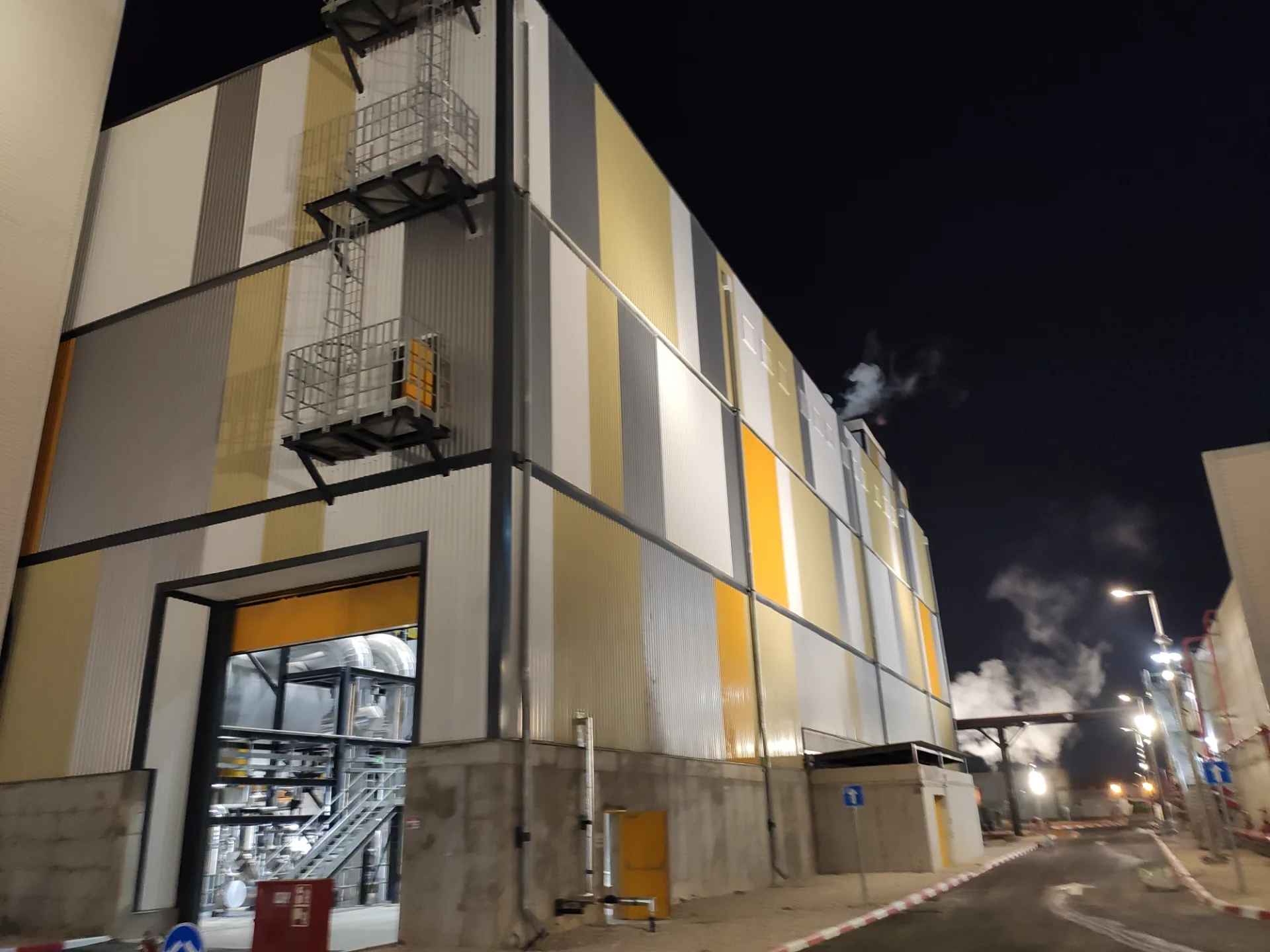 Lit color-block cladding on the plant facade