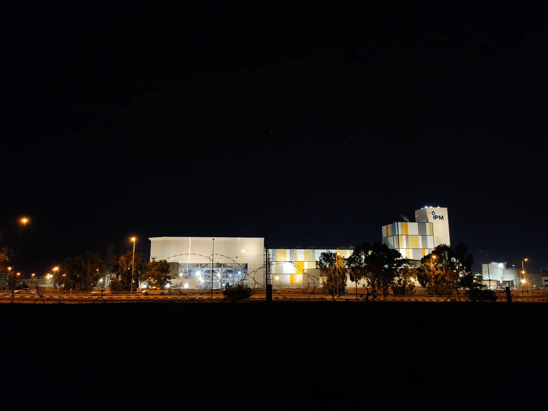 The power station lit against the night landscape