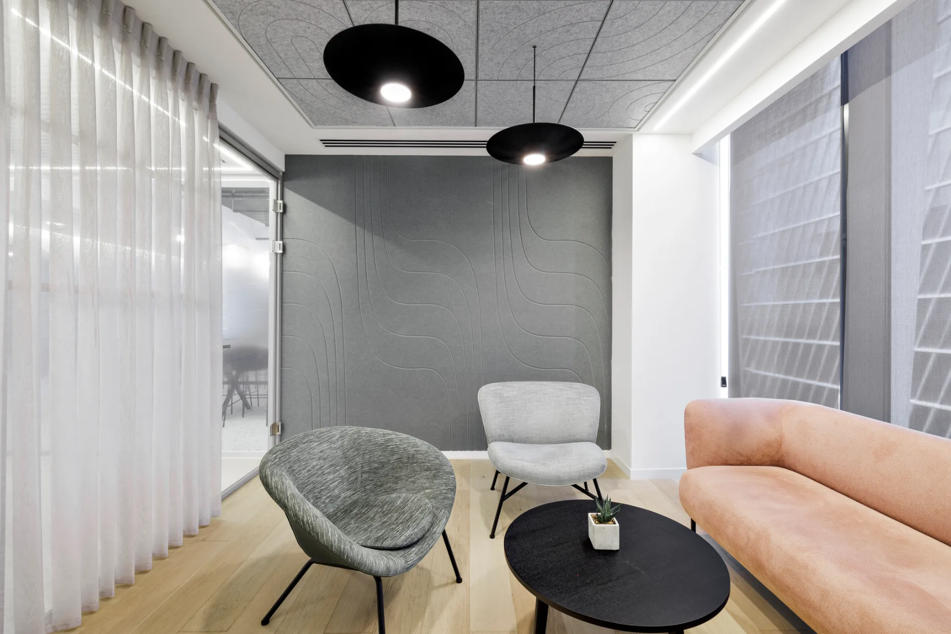 Bright open work area beside glazed offices