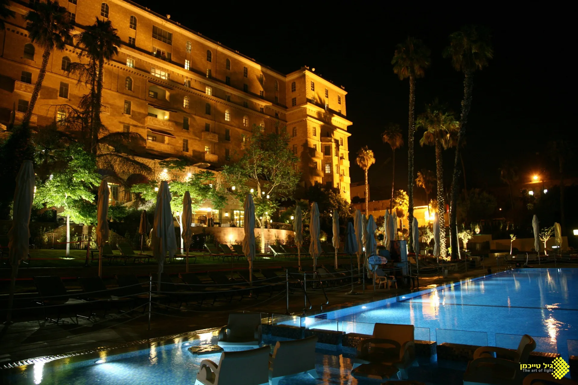 Lit hotel facade above the pool