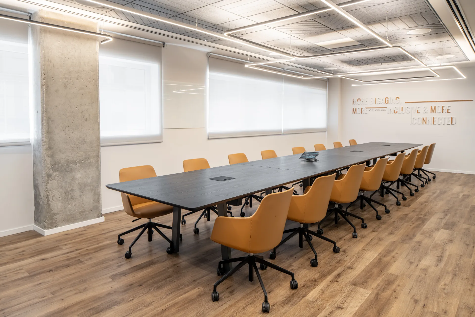 Boardroom with mustard chairs and an acoustic ceiling