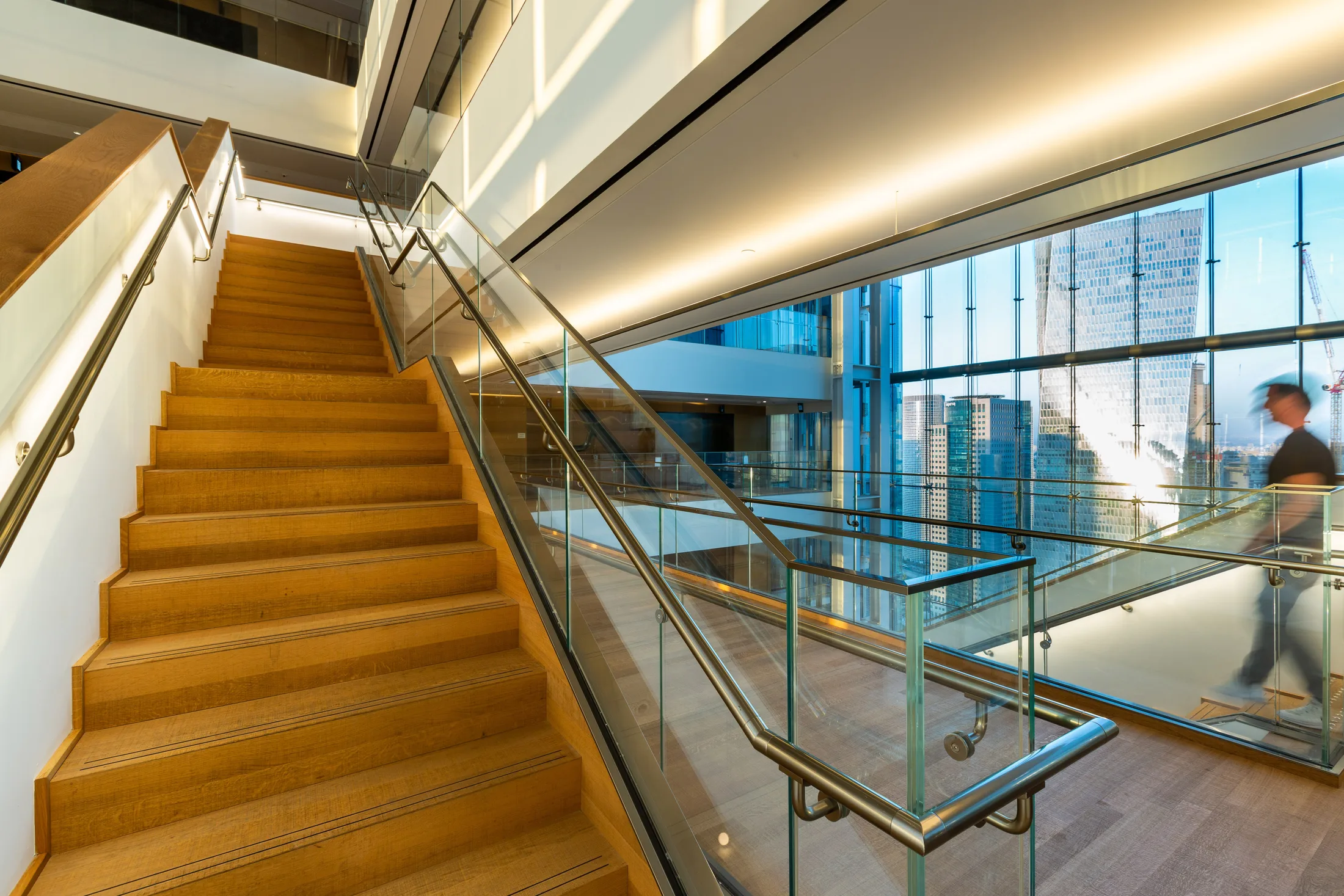 The atrium stairs in daylight with wood cladding