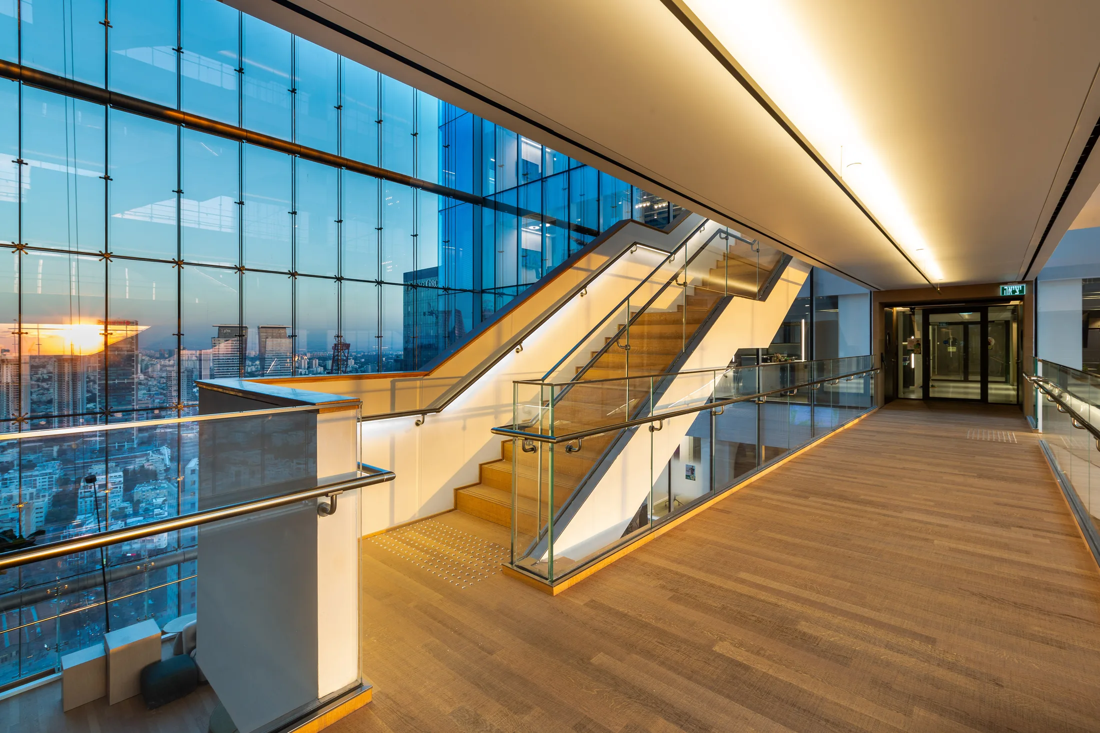The atrium stairs at night in warm light