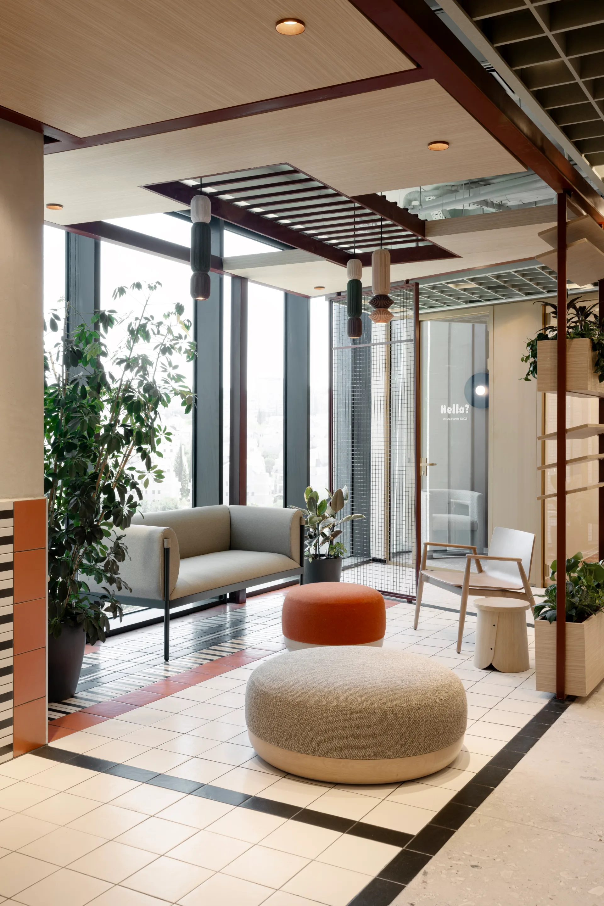 Lounge with cylinder pendants and a city view