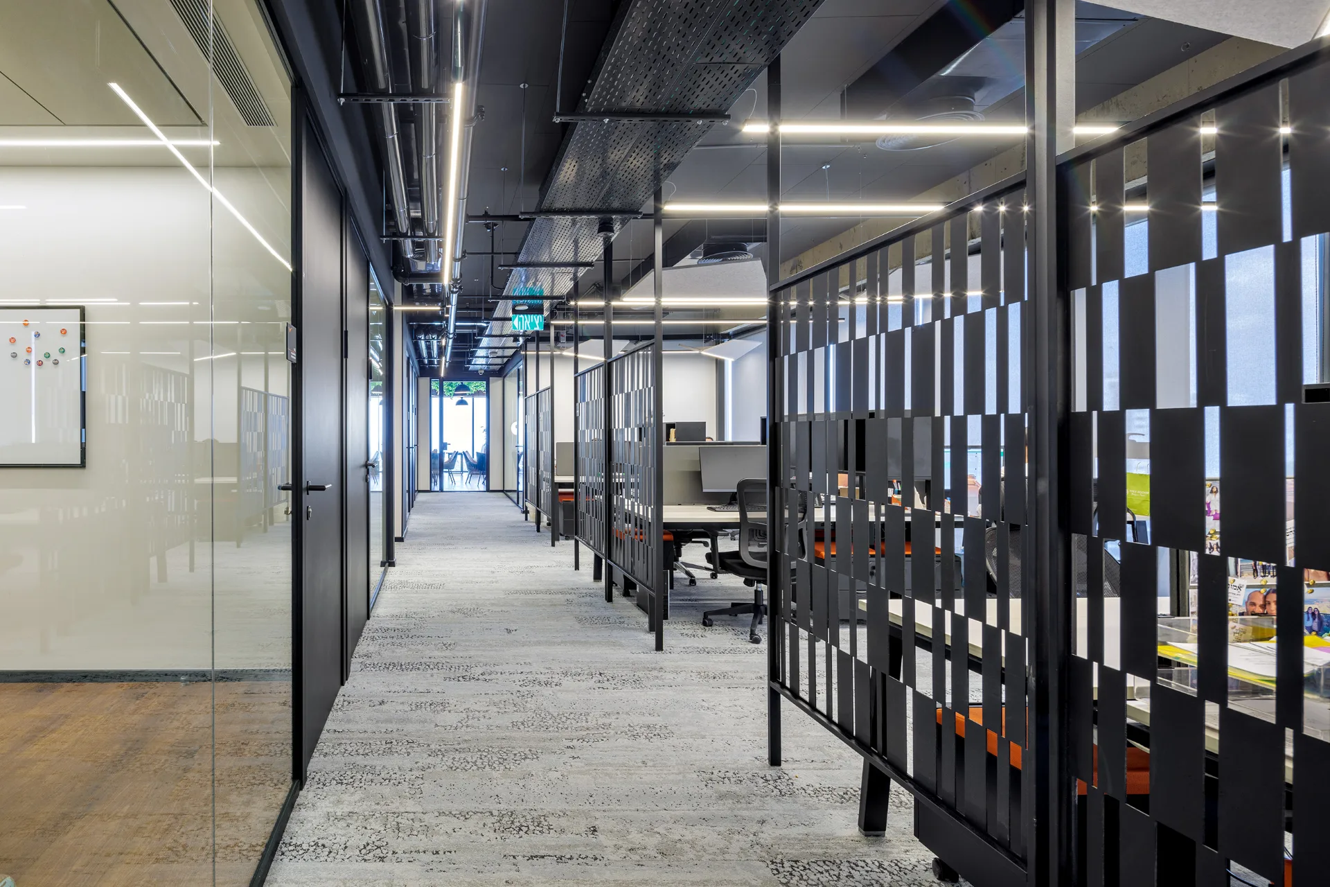 Open workspace beside glass-partitioned offices