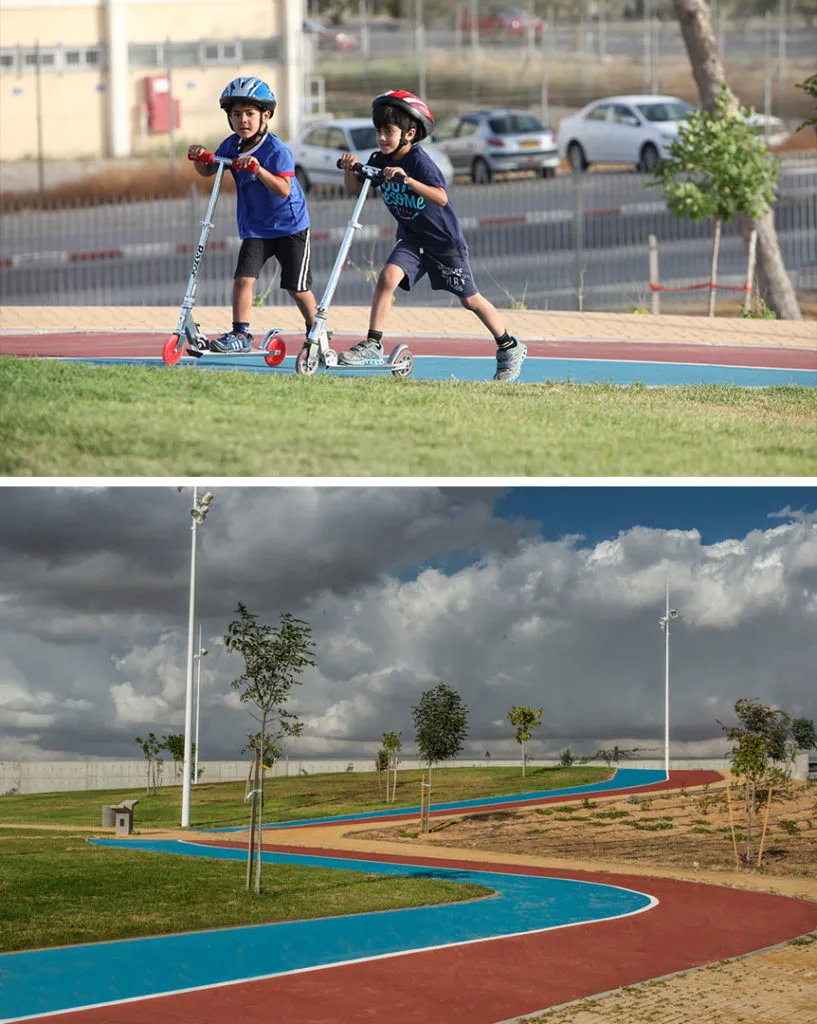 Children on scooters and the winding blue-and-red paths through the park
