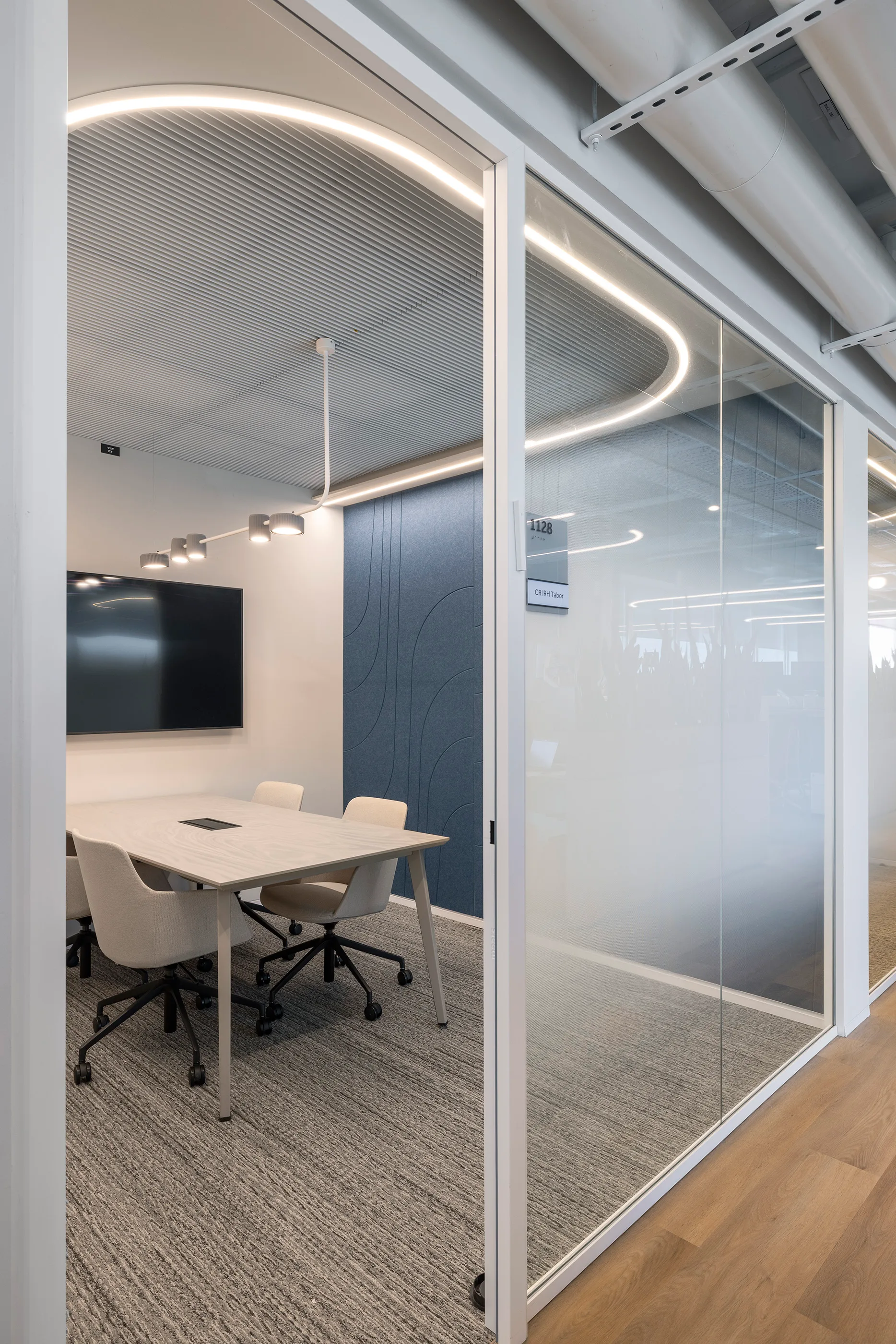 Circulation corridor along glass-partitioned offices