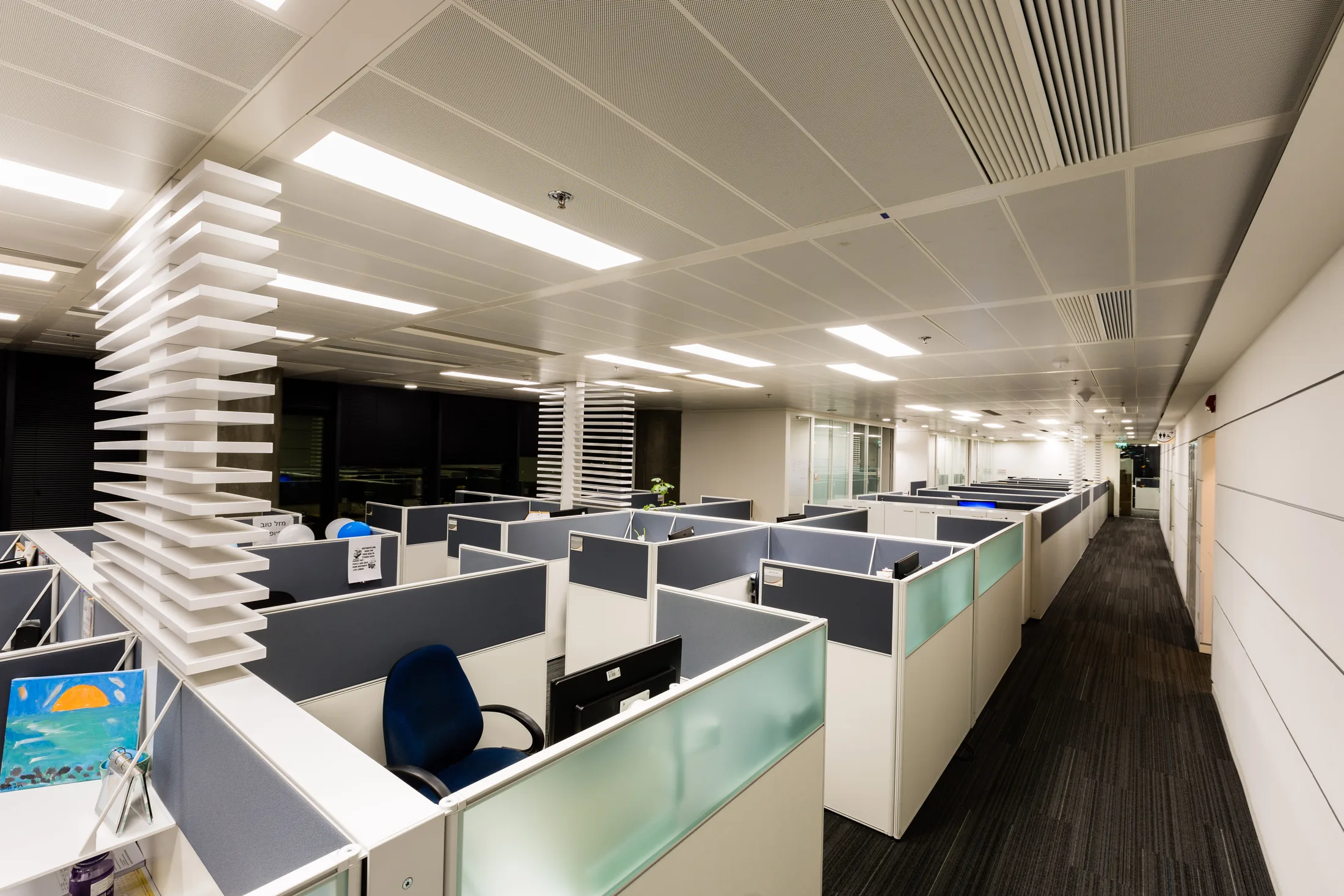 An open office floor with frosted-glass partitions