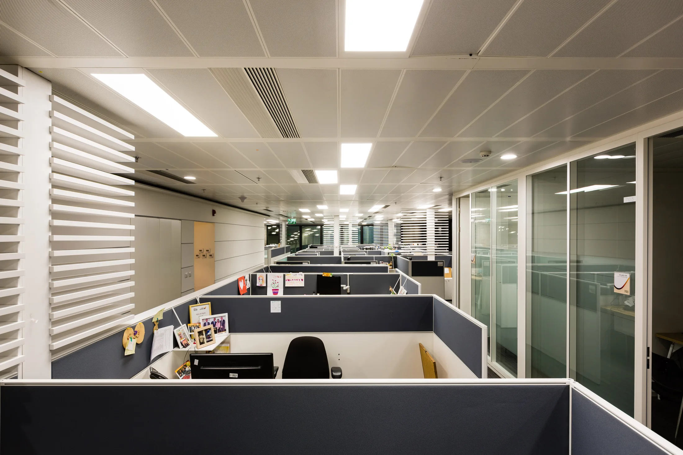 An open office floor under recessed panel lighting
