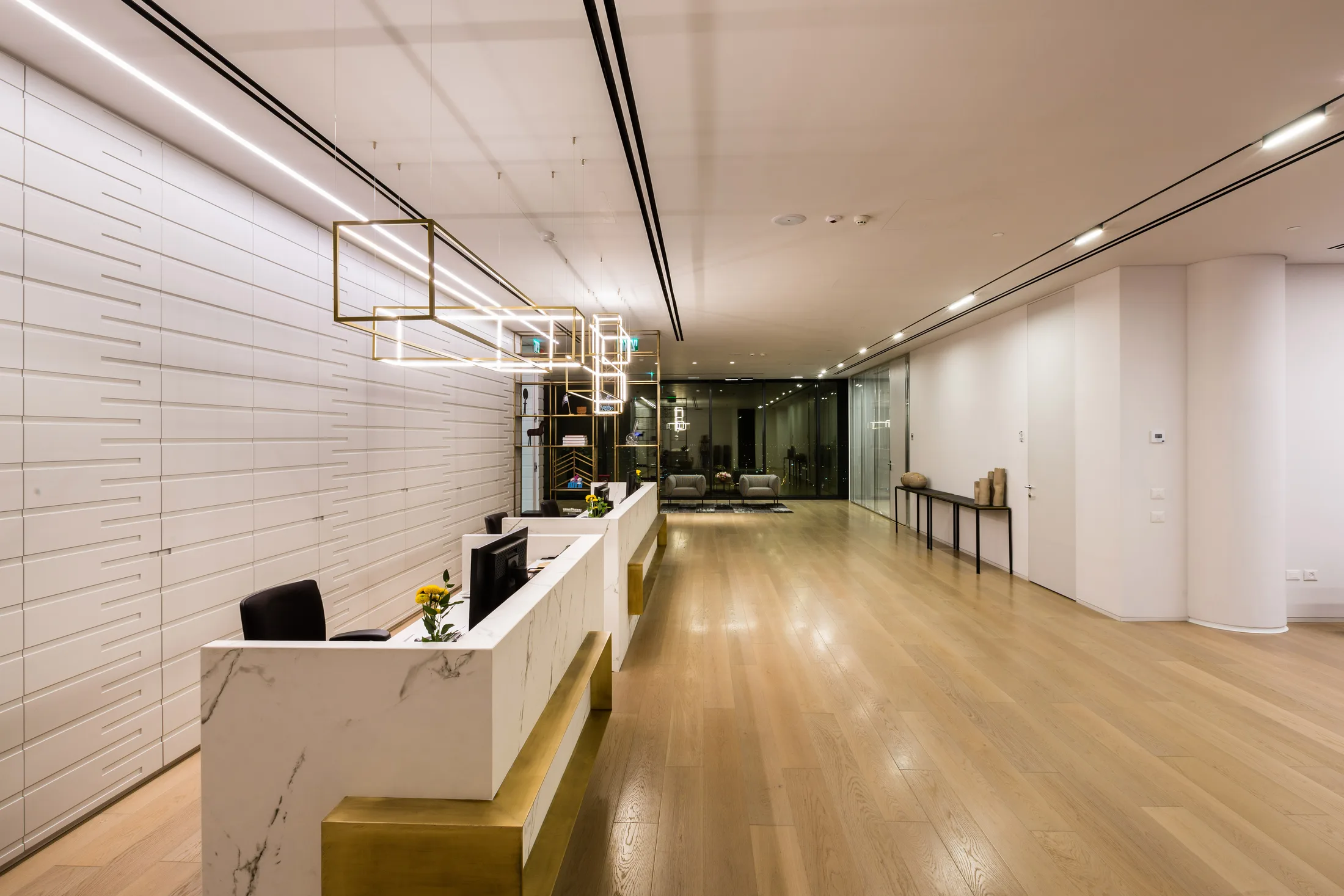 An executive floor reception with a decorative brass pendant