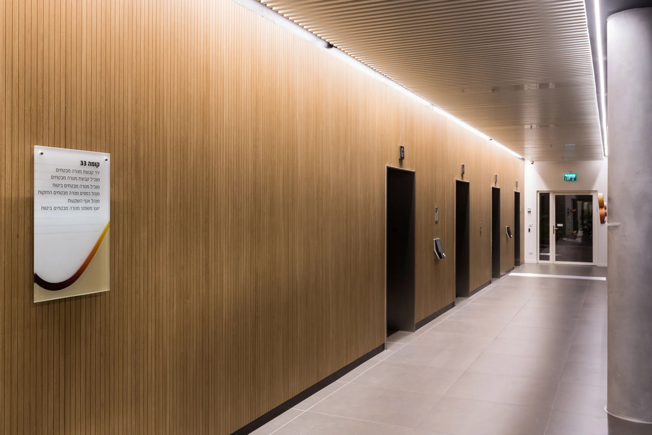 A typical lift lobby with timber walls and concealed light