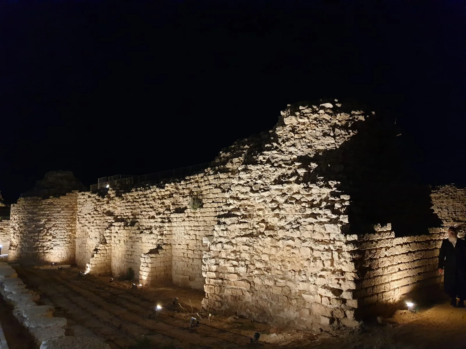 Kurkar wall grazed by in-ground uplights at night