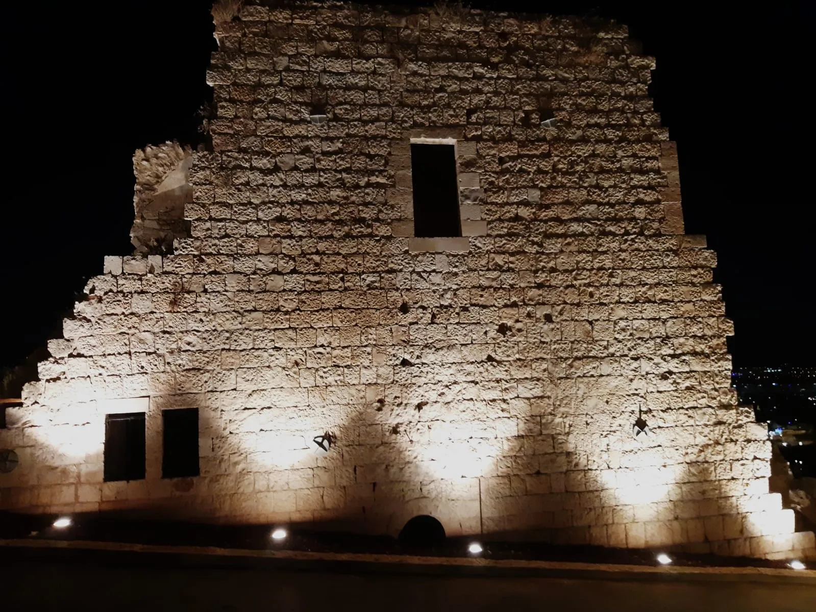 Illuminated historic stone wall
