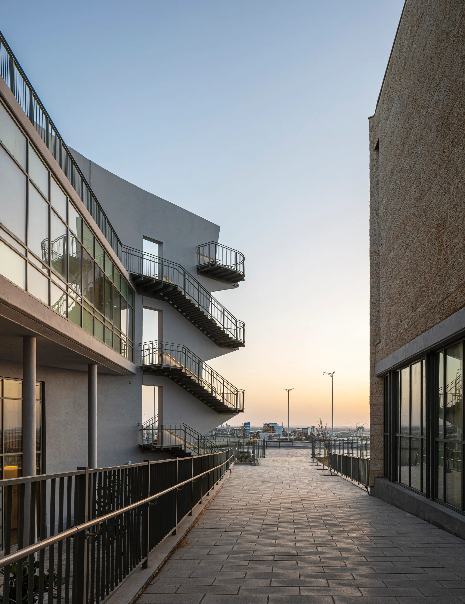 Stone facade and external stairs at dusk