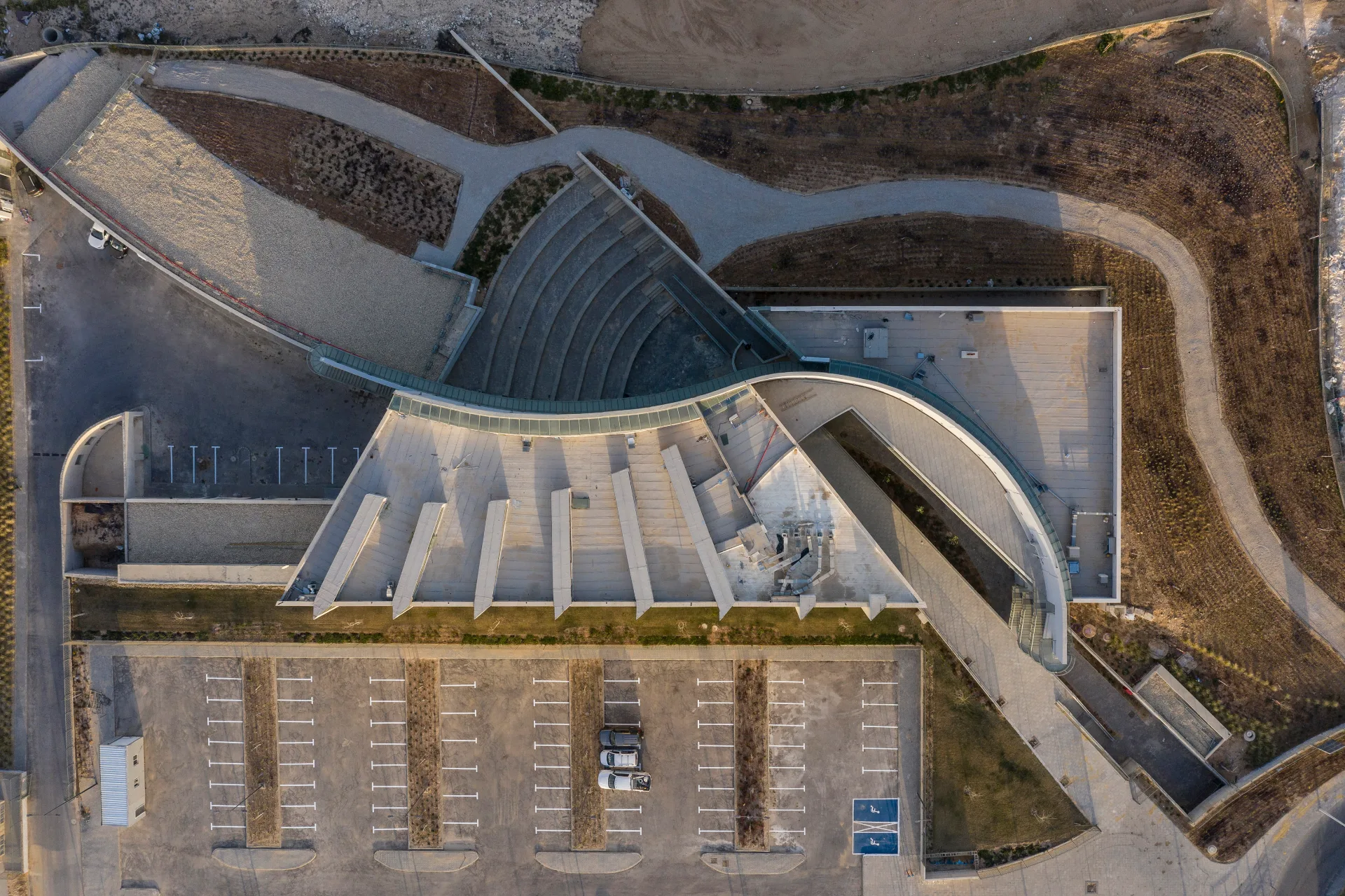 Aerial view of the curving roof in the desert landscape