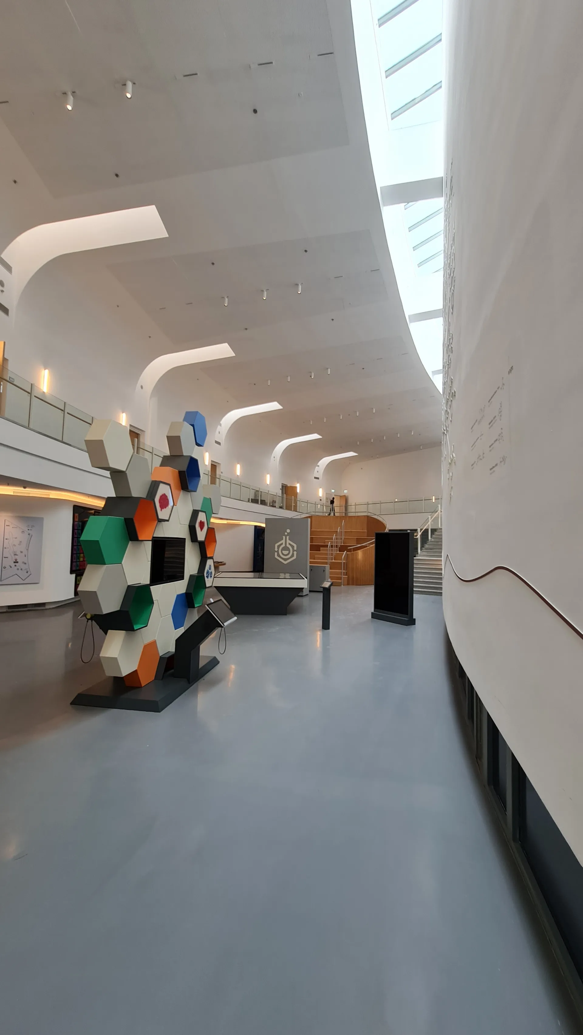 Entrance lobby with a colourful artwork and curving ceiling