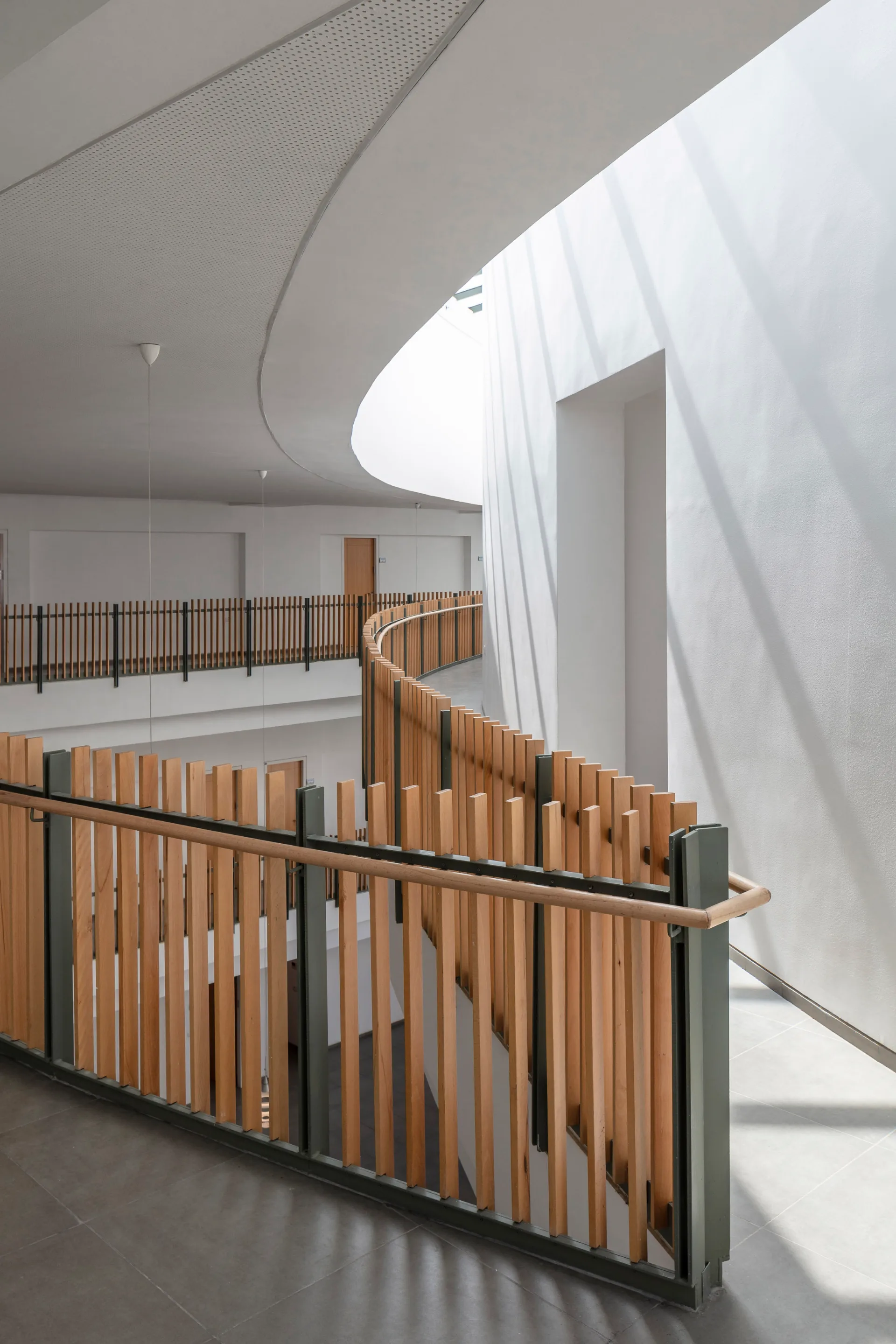 The curving timber balustrade in the atrium