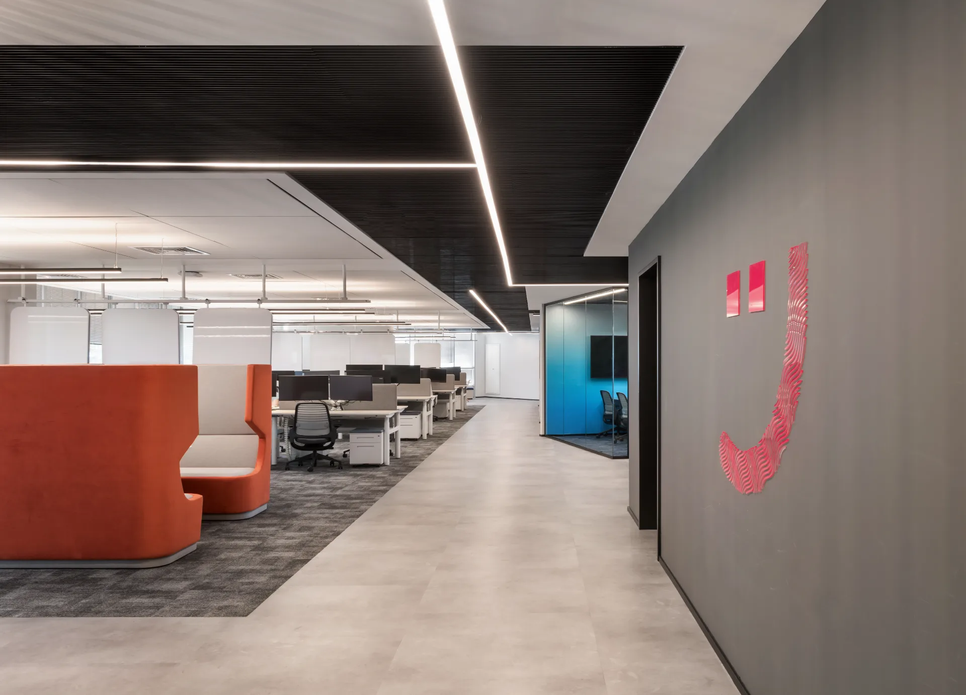 Open workspace with light lines on a black ceiling
